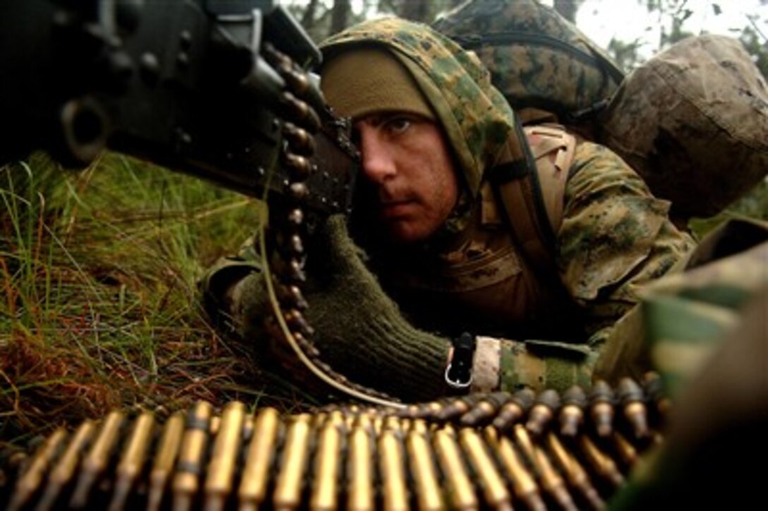 U.S. Marine Corps Lance Cpl. Michael Eck readies his M-60 machine gun for a surprise ambush on opposing forces during exercise Talisman Sabre 2007 in Shoalwater Bay, Australia, on June 22, 2007.  Eck is attached to the 3rd Marine Expeditionary Brigade.  The biennial exercise is designed to train Australian and U.S. forces in planning and conducting combined task force operations, which will help improve combat readiness and interoperability.  