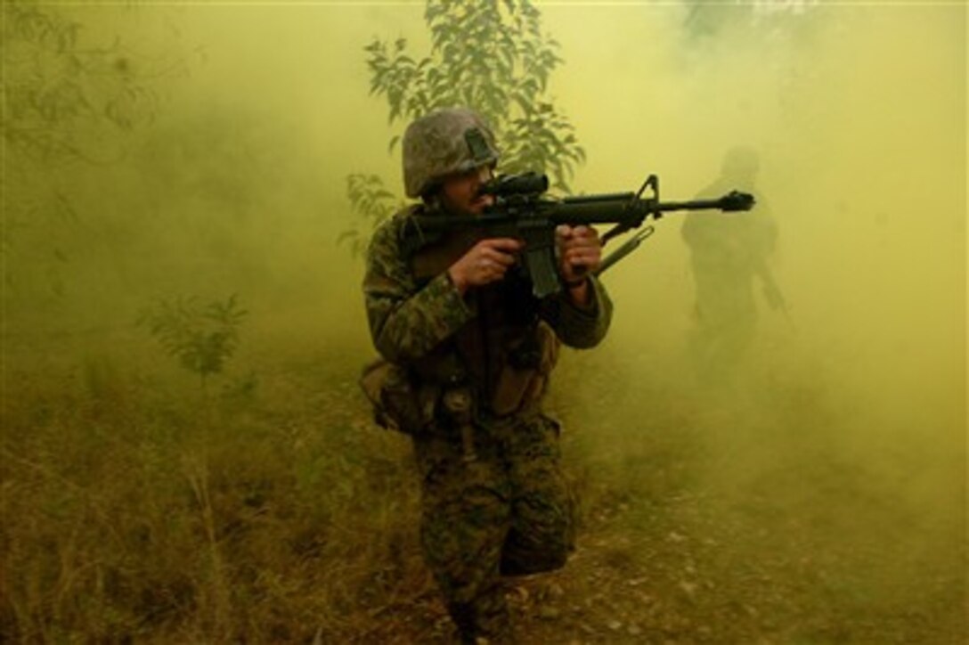 A U.S. Marine engages in a firefight with opposing forces during exercise Talisman Sabre 2007 in Shoalwater Bay, Australia, on June 22, 2007.  The biennial exercise is designed to train Australian and U.S. forces in planning and conducting combined task force operations, which will help improve combat readiness and interoperability.  The Marine is attached to the 3rd Marine Expeditionary Brigade.  