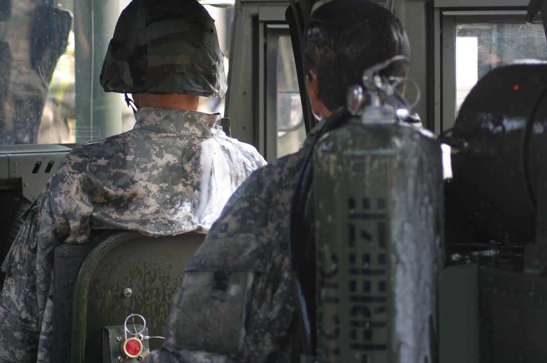 MARINE CORPS BASE CAMP LEJEUNE, N.C. (June 26, 2007)- Moments after the explosion inside a humvee, Marines observe how the system extinguished the flames within the vehicle and on dummy passengers. The vehicle uses two tanks filled with Artic Fire Freeze on each side of the humvee. The fire suppressant not only extinguishes the fire, it also lowers the temperature of a surface back to touchable conditions.