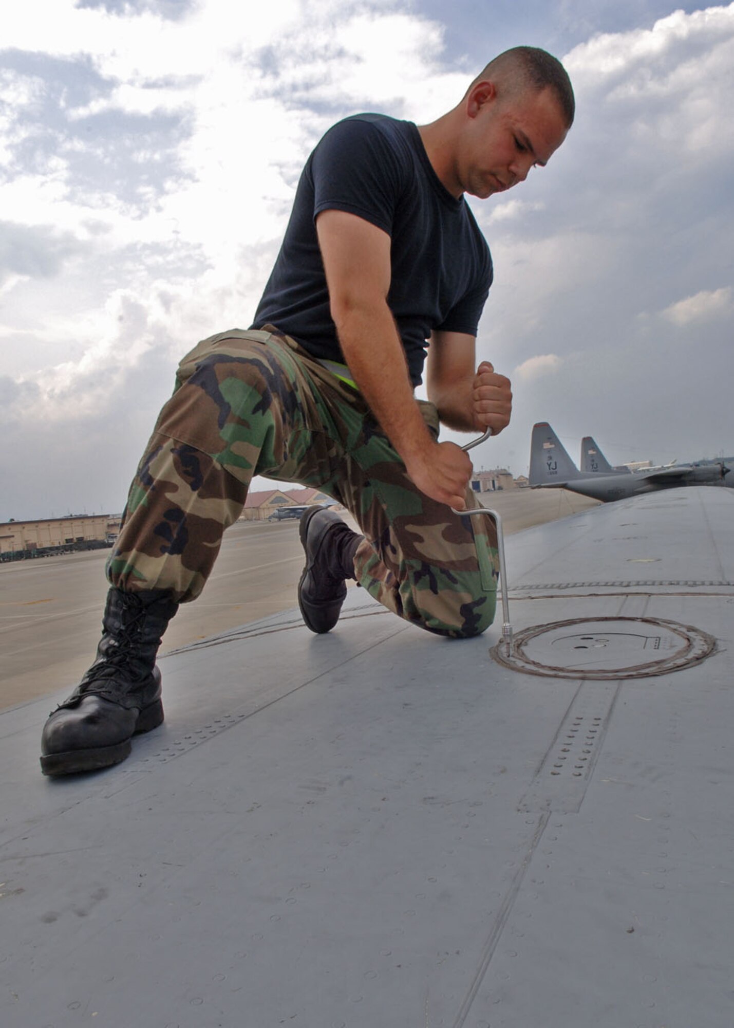 Airman Dean Atwa tightens a dry bay panel on top of a C-130 Hercules. Amn Atwa is a communication navigations and mission systems apprentice with the 374th Aircraft Maintenance Squadron.
(U.S. Air Force photo by Senior Airman Veronica Pierce)
