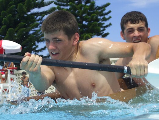 Senior Airman David Windle and Airman 1st Class Justin Crawford, both from 18th Munitions Squadron, paddle to the finish line in a cardboard boat they made only a few hours before as part of the build-a-boat contest June 16 at Hagerstrom pool, Kadena Air Base, Japan.  More than 50 people divided among seven teams competed. Competitors were only supplied with a roll of duct tape, three large pieces of cardboard and a cutting knife.  “Team Ammo” won first place overall in time and sea worthiness.
U.S. Air Force photo/Senior Airman Jeremy McGuffin