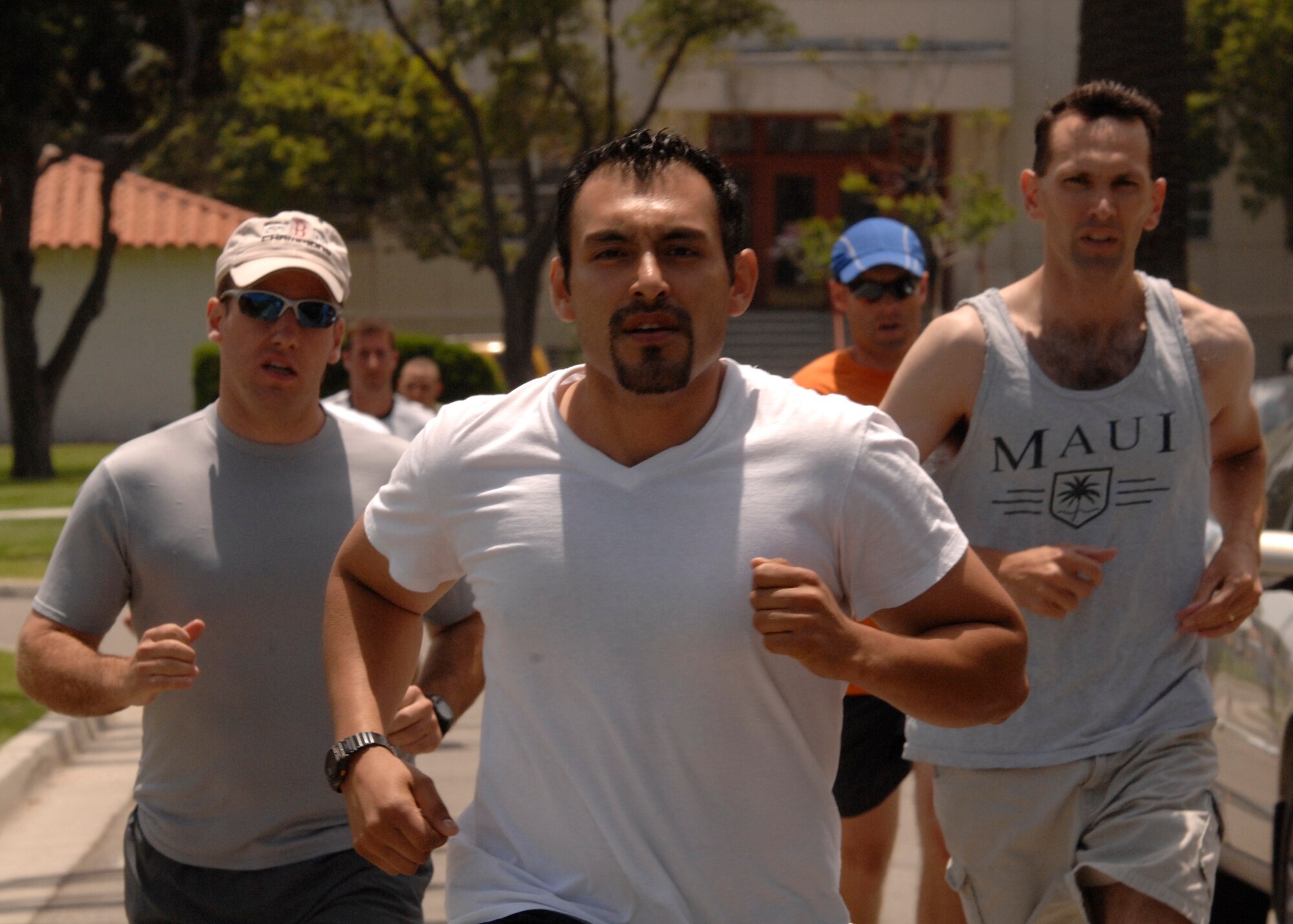 Lt. Michael Bowker, Tony Buenrostro and Lt. Gary Samson lead the pack during the 1 ½ mile run portion of the War Fit Challenge event at the 2007 SMC Sports Day, June 15. The Space Superiority Systems Wing took the day’s overall title. (Photo by Joe Juarez)