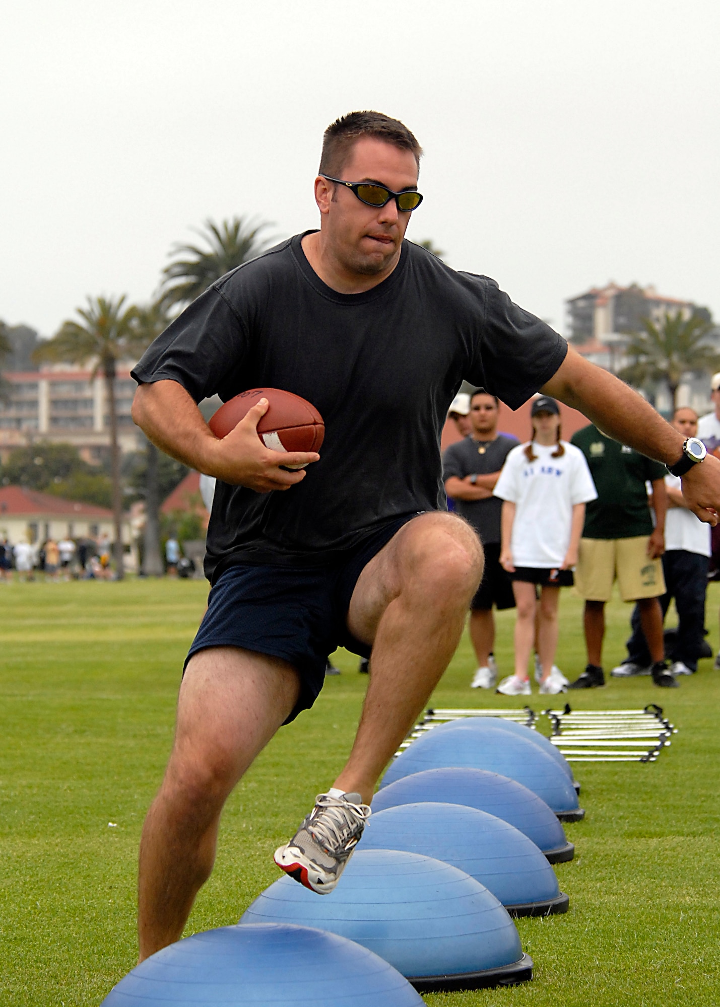 Capt. Ross Johnston runs the obstacle course during the Quarterback Agility event at the 2007 SMC Sports Day, June 15. The Space Superiority Systems Wing took the day’s overall title. (Photo by Joe Juarez)