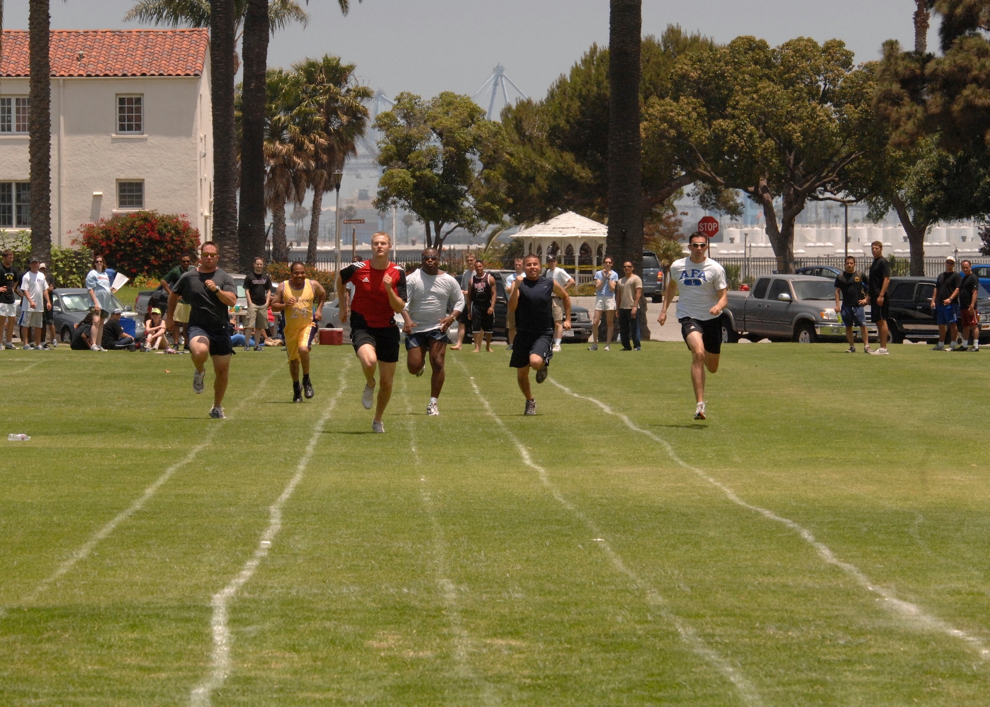 LAAFB Airmen run in the 100 yard dash at the 2007 SMC Sports Day, June 15. Lt. Curtis Engelson, wearing the red shirt, won this heat. The Space Superiority Systems Wing took the day’s overall title. (Photo by Joe Juarez)