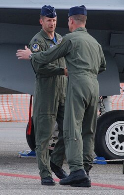 EIELSON AIR FORCE BASE, Alaska--Lt. Col. Deiter Bareihs, 18th Fighter Squadron commander, and Lt. Col. Quentin Rideout, 355th FS commander, shake hands after their A-10 and F-16 flyover for a flag-folding ceremony June 23. The ceremony marked the de-activation of the 355th FS and the 18FS. (U.S. Air Force photo by Senior Airman Justin Weaver)
