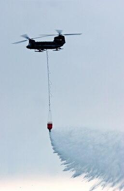 EIELSON AIR FORCE BASE, Alaska--A CH-47 Chinook makes a water drop during the 2007 Soaring into Solstice Open House June 23 here. More than 25,000 people attended the all-day event featuring aerial and ground demonstrations including flybys, simulated airfield attacks, and aerobatic maneuvers as well as concessions, live music and aircraft displays. (U.S. Air Force photo by Senior Airman Justin Weaver)