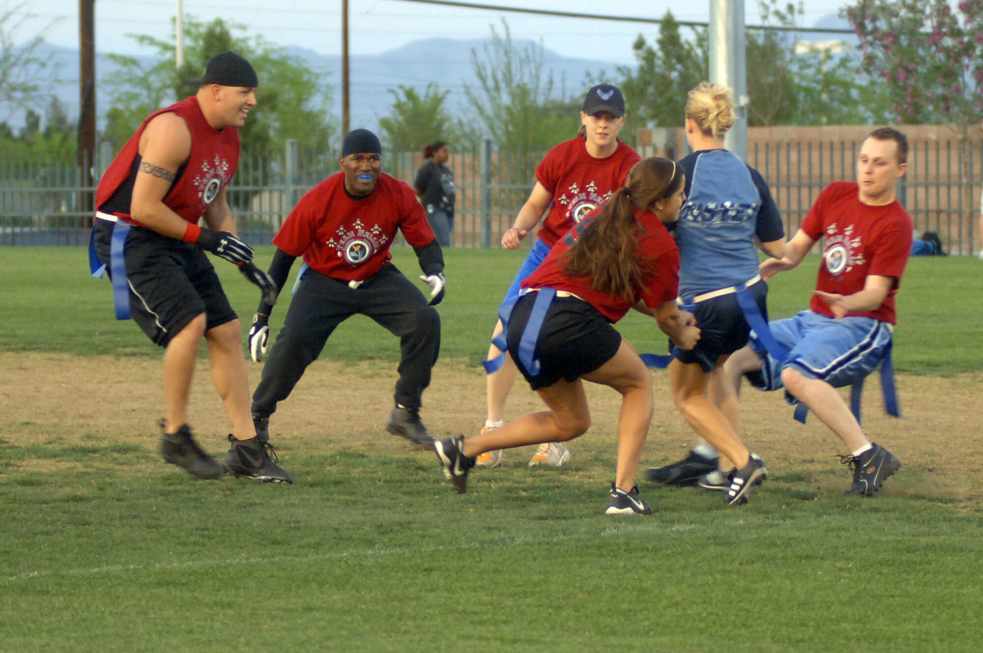 Team Nellis closes in on their oponent in the 2007 Las Vegas Corporate Challenge flag football event.  Around 350 participants and 100 volunteers represented Nellis this year.