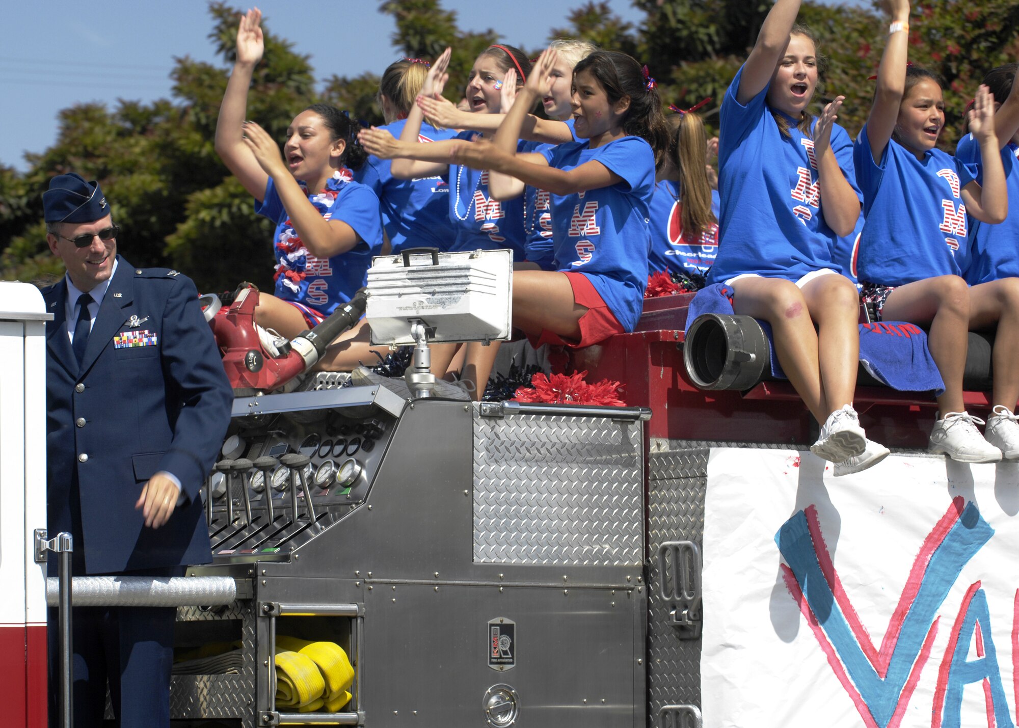 Col. Benjamin Huff, 30th Mission Support Group commander, rides on a fire engine with the Vandenberg Middle School Cheerleaders during the 55th Annual Flower Festival Parade in Lompoc on June 23.  The festival celebrated the theme of American History on Parade as bands, floats, equestrian units, drill teams, and clowns entertained the crowd. (U.S. Air Force photo/Airman 1st Class Christian Thomas)