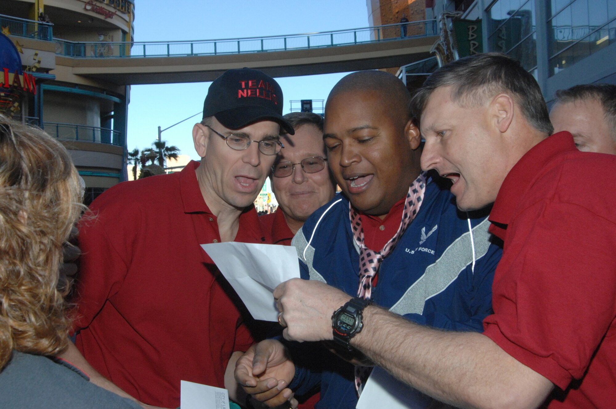 United States Air Force Colonel Michael Bartley (right), 99th Air Base Wing Commander, Chief Master Sergeant Raymond Campbell (middle), 99th Logistics Readiness Squadron Chief Enlisted Manager and Colonel Timothy Green (left), 99th Mission Support Group Commander, joins in on a song to complete the last obstacle of the opening events for the 2007 Corporate Challenge Thursday March 29, 2007 Las Vegas, Nevada.
(U.S Air Force Photo by: Senior Airman Larry E. Reid Jr.)  