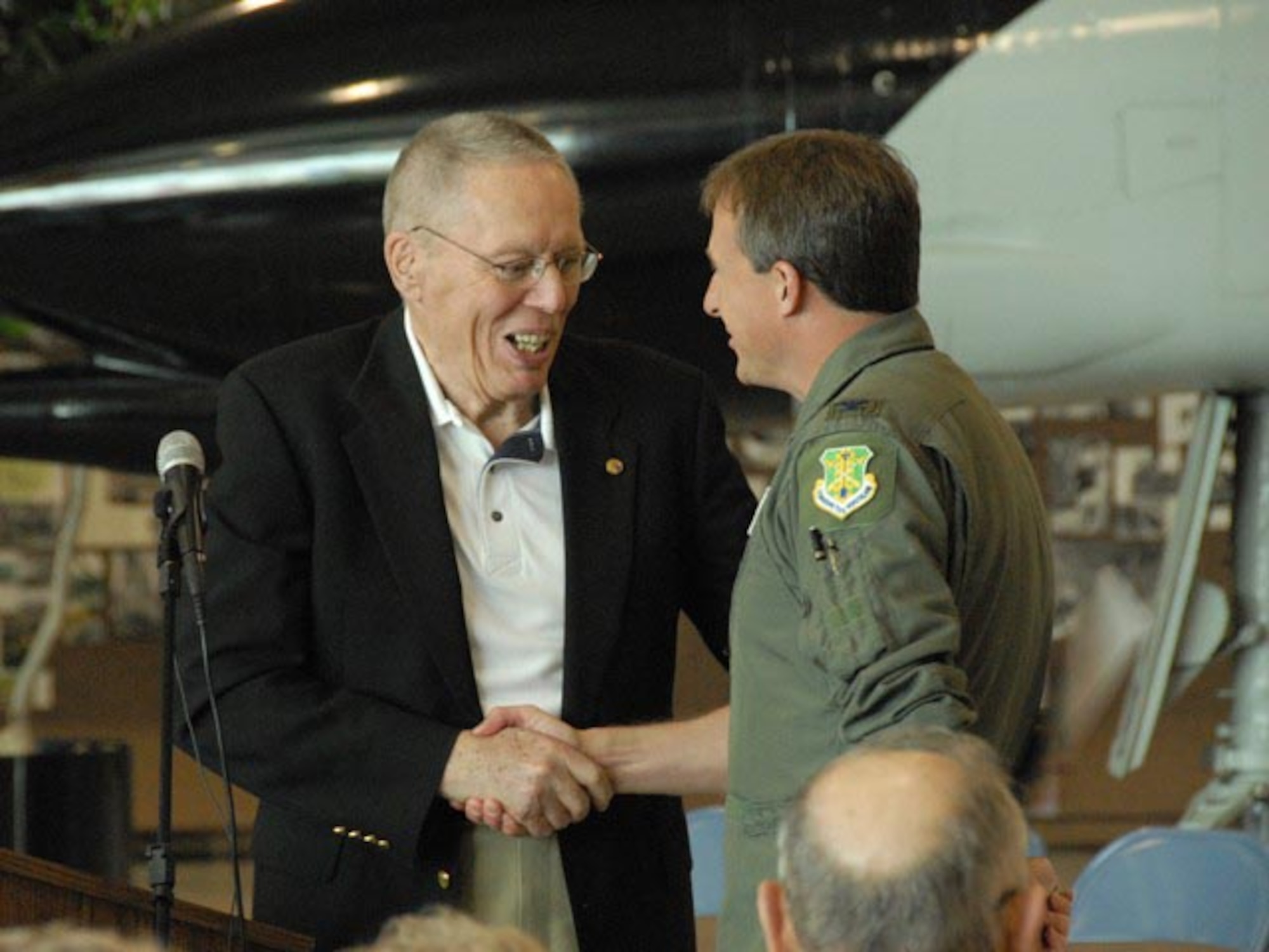 Retired Maj. Gen. Alexander P. McDonald, the former North Dakota adjutant general, shakes hands with Col. Robert J. Becklund, 119th Wing commander, as they discuss their actions during events that happened 20 years earlier.
