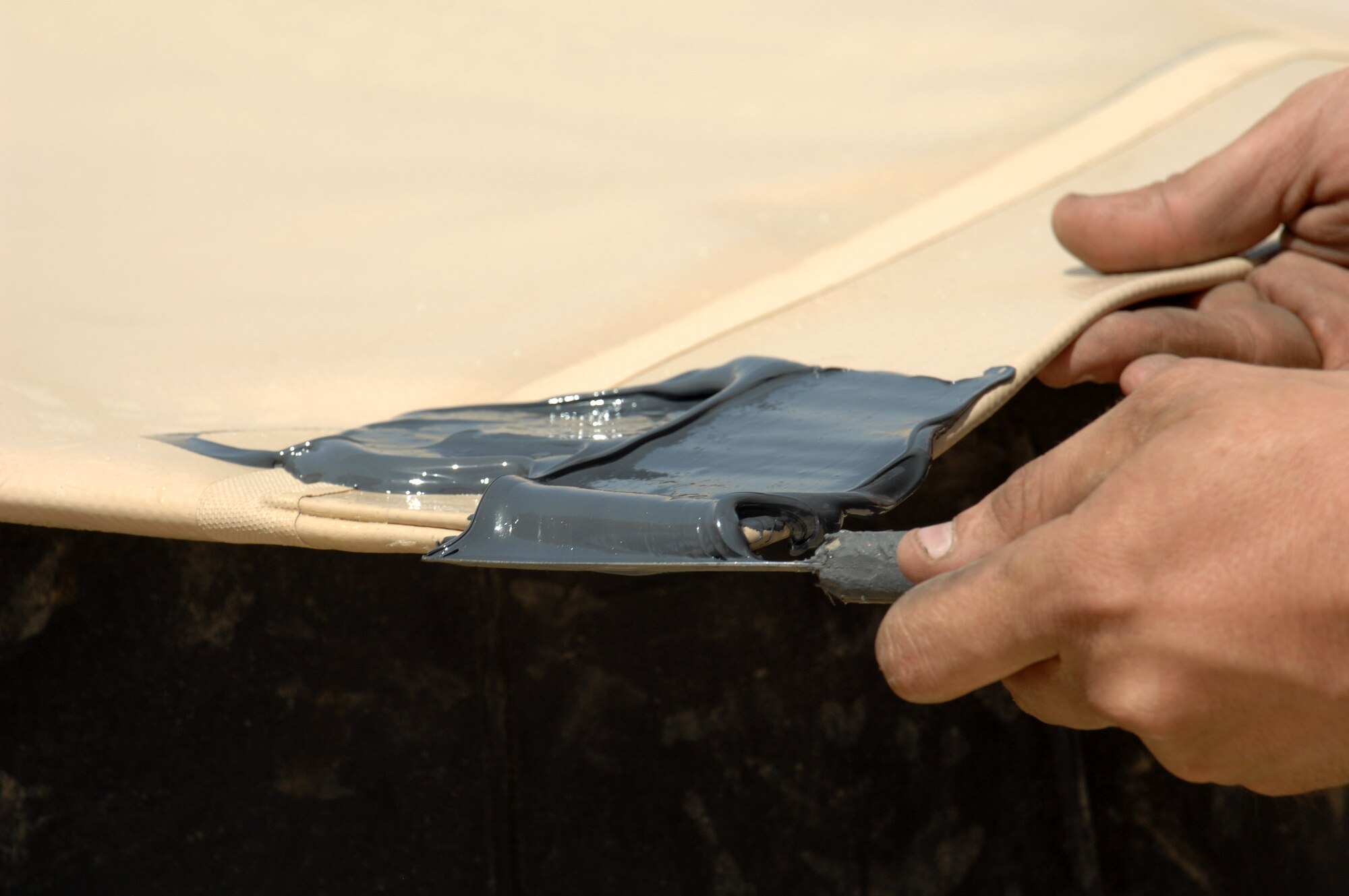 The corner of a new fuel bladder is sealed during installation June 19 at Kirkuk Regional Air Base, Iraq.  The bladder will be filled with JP-8 jet fuel.  Fuel storage bladders are collapsible, flexible storage containers that provide temporary as well as long term fuel storage.   (U.S. Air Force photo/Senior Airman Kristin Ruleau)