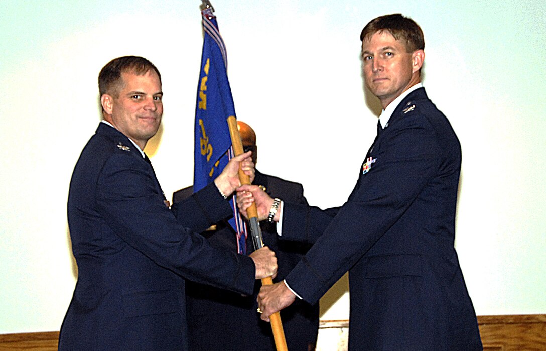 Col. James King, 82nd Medical Group commander, presents the guidon to Col. Jeffrey Thompson, incoming 82nd Dental Squadron commander June 25 at the 82nd DS change-of-command ceremony. (U.S. Air Force photo/Harry Tonemah)