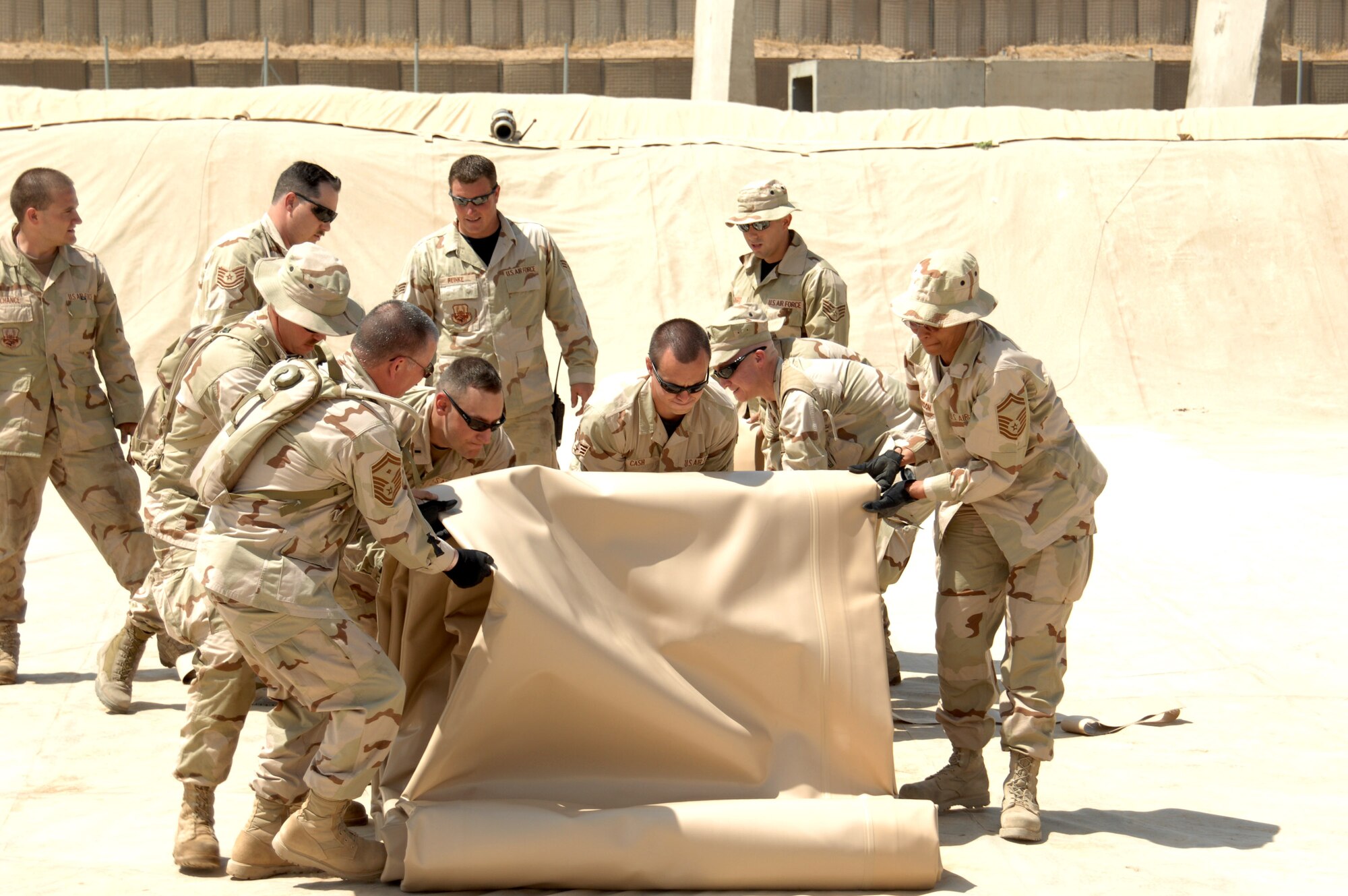 Airmen in the 506th Expeditionary Logistics Readiness Squadron roll out a new fuel bladder in a fuel pit June 19 at Kirkuk Regional Air Base, Iraq.  The bladder will be filled with JP-8 jet fuel.  Fuel storage bladders are collapsible, flexible storage containers that provide temporary as well as long term fuel storage. (U.S. Air Force photo/Senior Airman Kristin Ruleau)