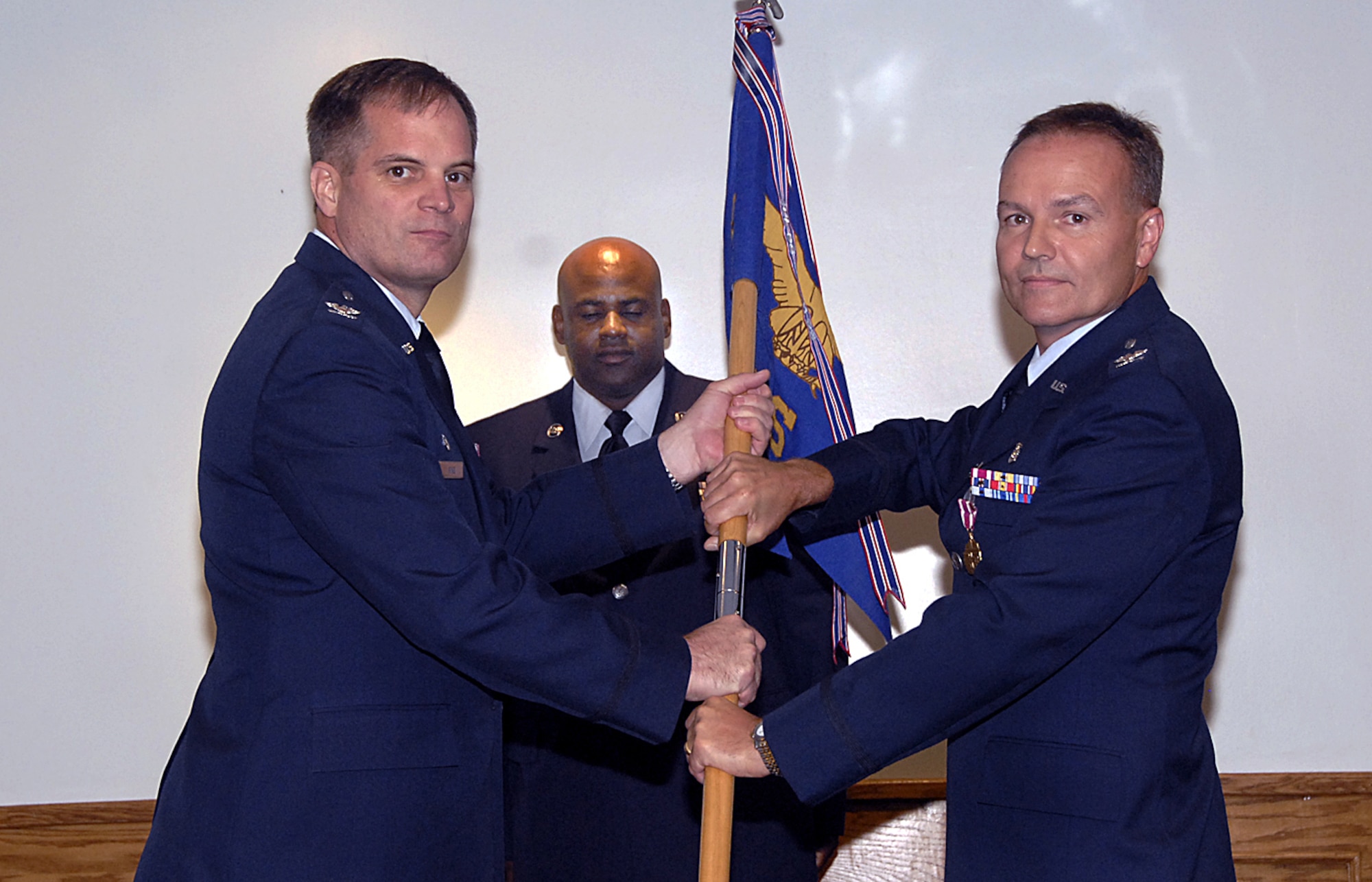 Col. James King, 82nd Medical Group commander, accepts the guidon from Col. Michael.Klepczyk, outgoing 82nd Dental Squadron commander June 25 at the 82nd DS change-of-command ceremony. (U.S. Air Force photo/Harry Tonemah)