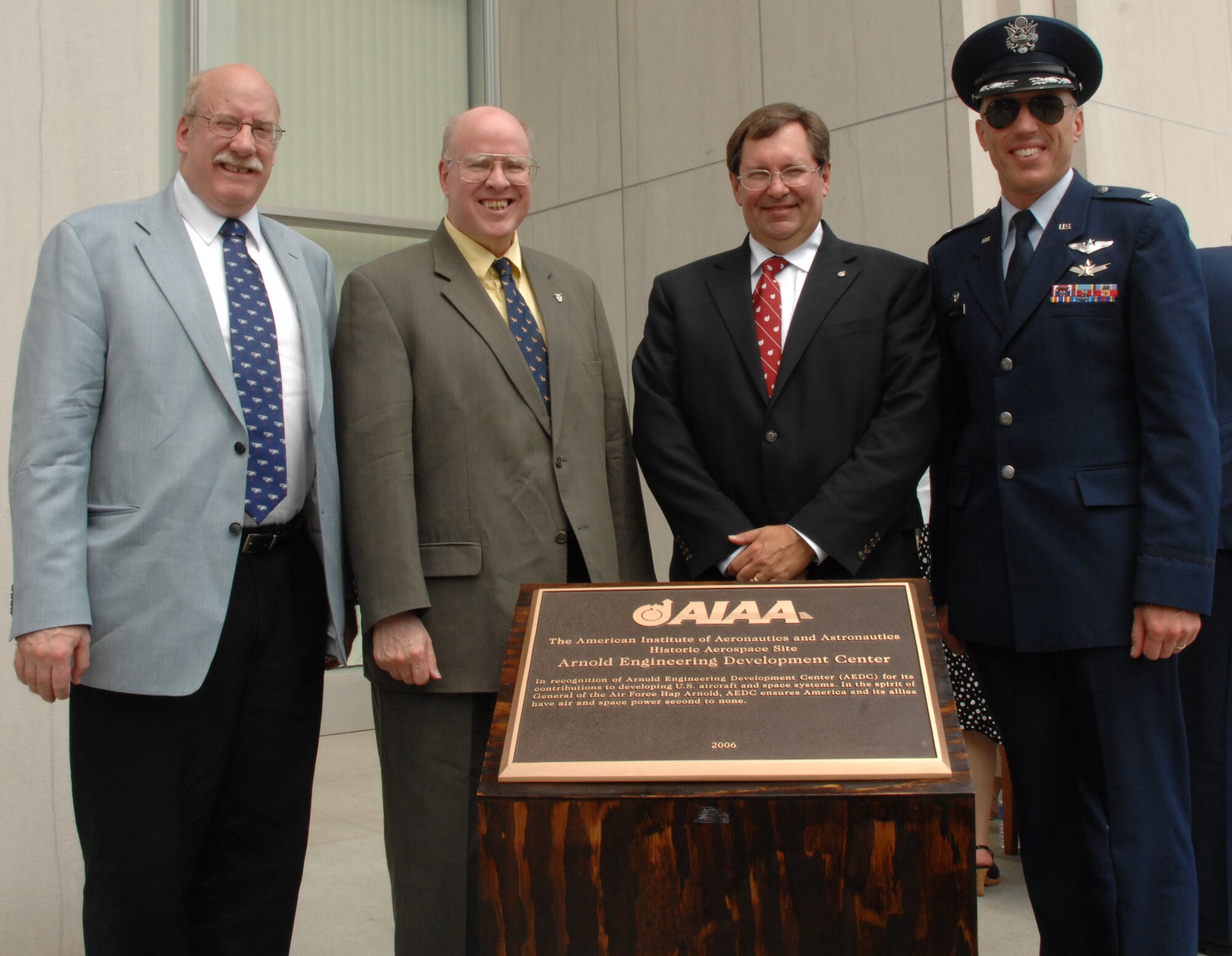 Pictured from left to right: Arnold Engineering Development Center (AEDC) Historian David Hiebert, Dr. Richard Hallion, former Air Force Historian, Steven Noneman, mission manager for the Lunar Crater Observation and Sensing Satellite at NASA’s Marshall Space Flight Center, and AEDC Commander Col. Art Huber stand in front of the bronzed-plaque idenitfying AEDC as an American Institute of Aeronautics and Astronautics aerospace historic site. (Photo by David Housch)