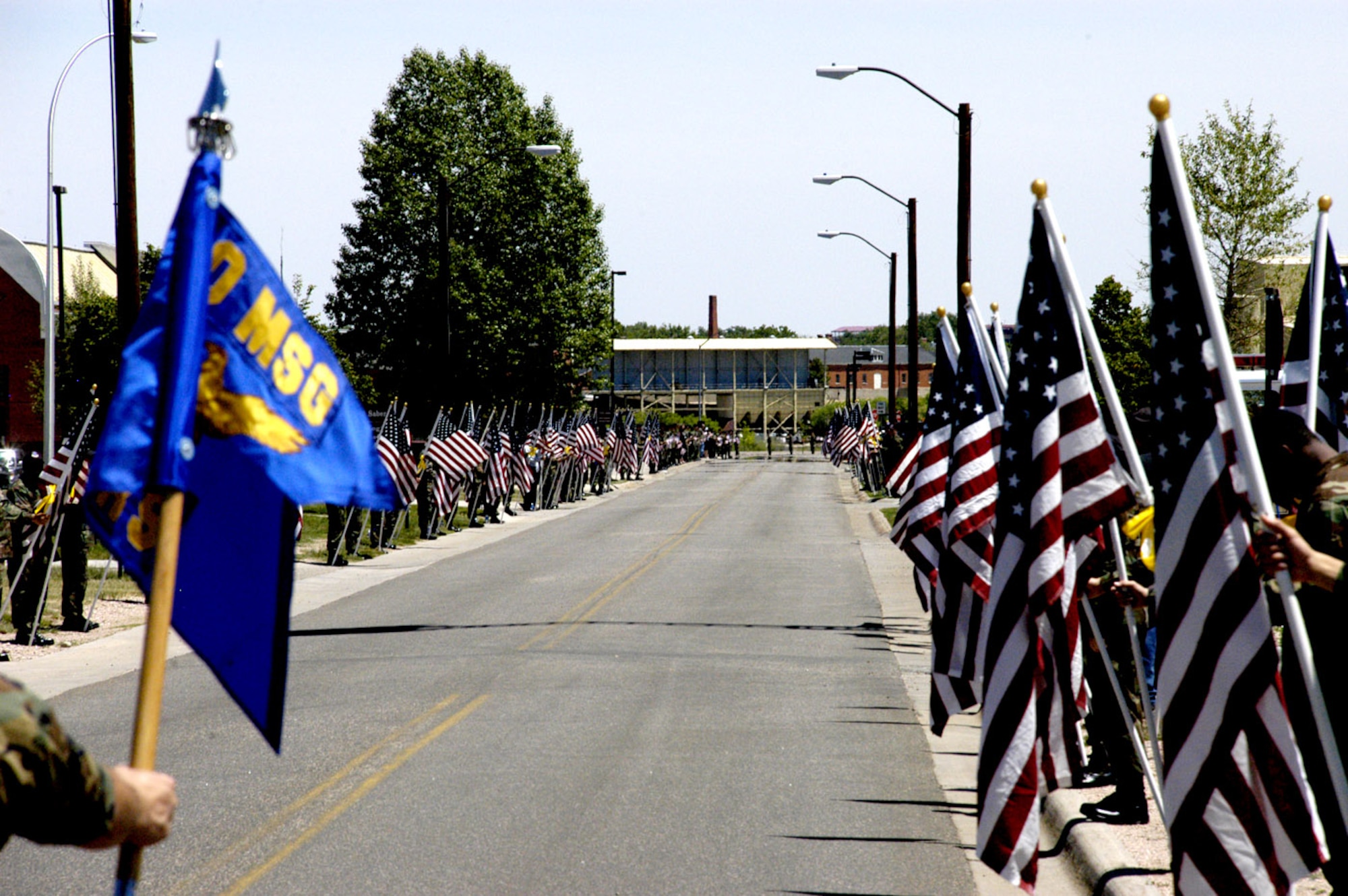 Family, friends and organizations from around Warren came out to pay their respect to the family of Airman 1st Class Eric M. Barnes during his memorial service held in Bldg. 1270 June 14. Airmen and civilians held flags, and lined Saber Road from Nebraska Avenue to Missile Drive, awaiting the arrival of the Barnes family (Photo by Staff Sgt. Chad Thompson).