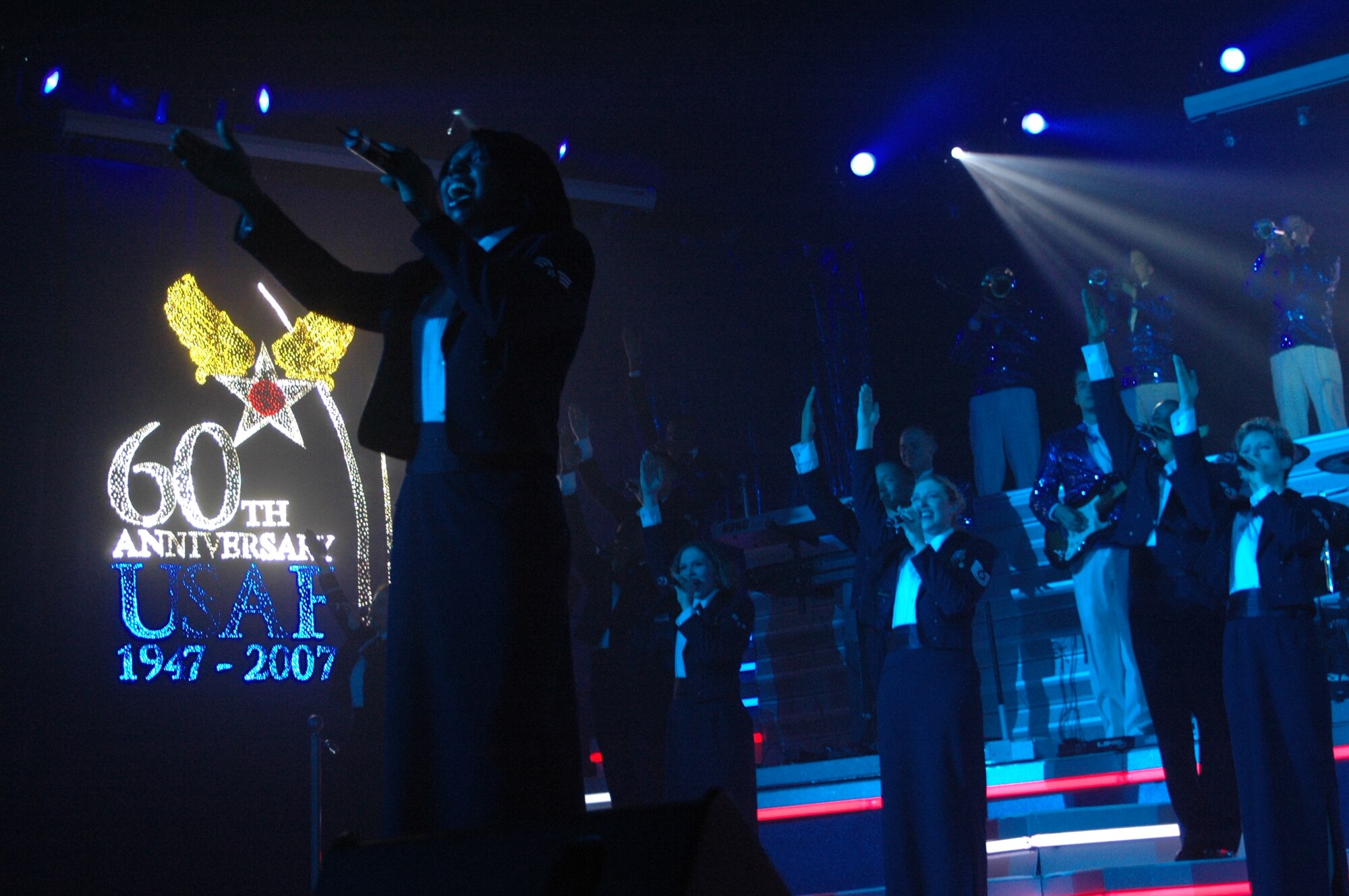 "Tops in Blue" vocalist Senior Airman Chante Walker, 2nd Engineer Squadron of Barksdale Air Force Base, La., sings "God Bless the USA" by Lee Greenwood at the Cheyenne Civic Center June 13. This concert marked the 10th performance of "The Fly-By" 2007 tour. For more information on tour schedules, visit http://www.topsinblue.com (Photos by Airman 1st Class Daryl Knee).