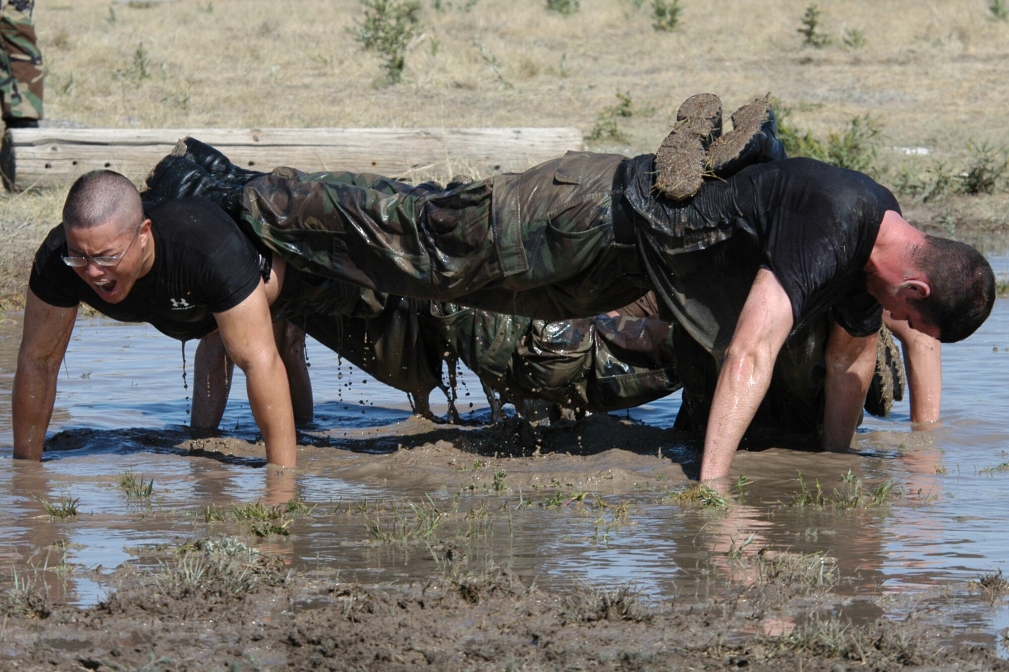 This was Bernie Ernst’s Department of Defense award-winning photo published in the Warren Sentinel July 7, 2006, highlighting the Crow Creek Challenge. Pictured are Airman 1st Class Andrew Reichmuth, Anthony King, Andrew Yu and Ryland McVay, 90th Security Forces Squadron doing fire team push-ups during the “team pain” portion of the 13th Annual Crow Creek Challenge held June 29, 2006 here (Photo by Bernie Ernst).