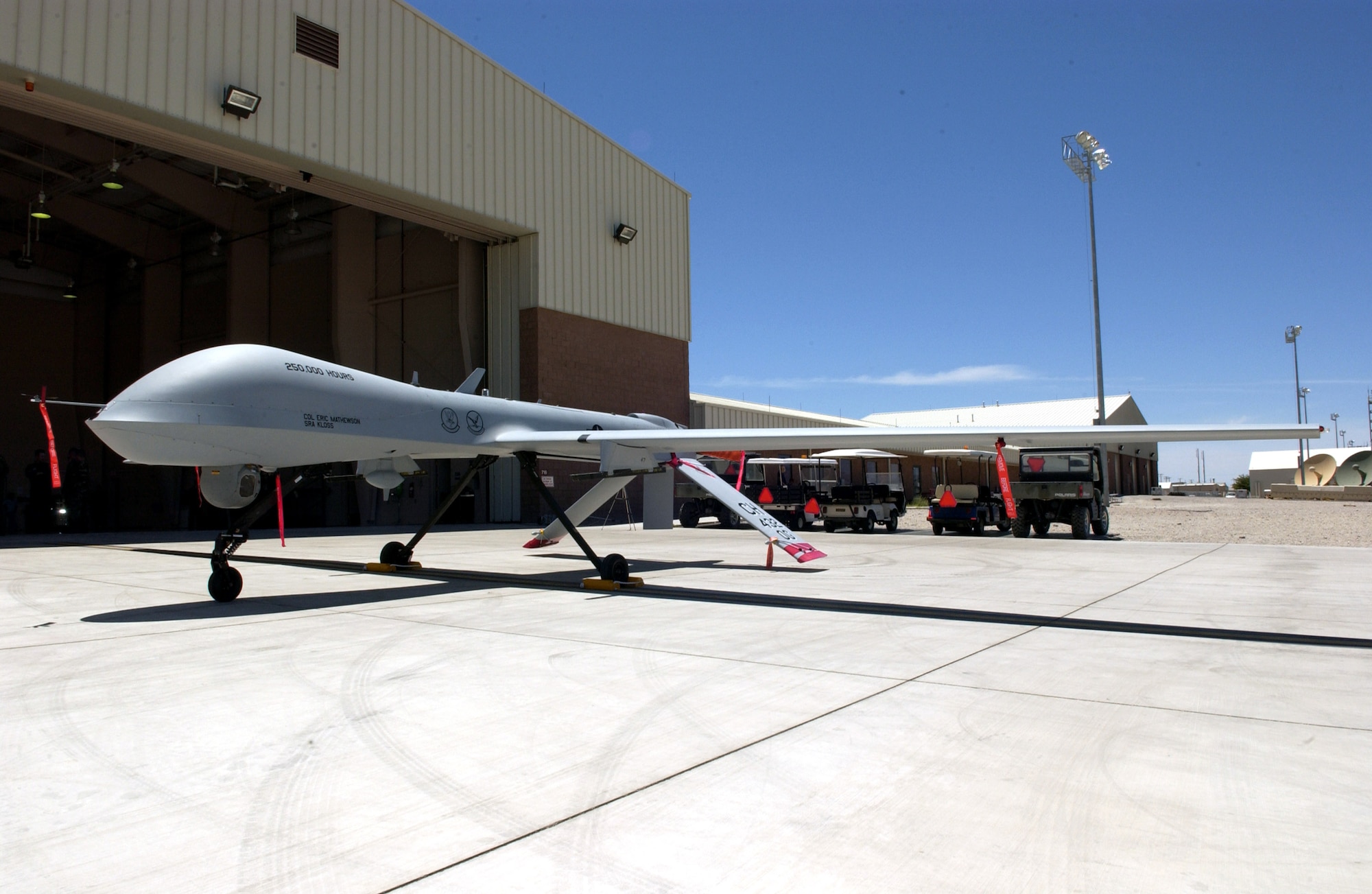 An MQ-1 Predator sits on display after commemorating the 250,000th flight hour June 22 at Creech Air Force Base, Nev. The Predator is assigned to the 11th Reconnaissance Squadron at Creech AFB. The MQ-1 Predator is a medium-altitude, long-endurance, remotely piloted aircraft. Its primary mission is interdiction and conducting armed reconnaissance against critical, perishable targets. (U.S Air Force photo/Senior Airman Larry E. Reid Jr.) 