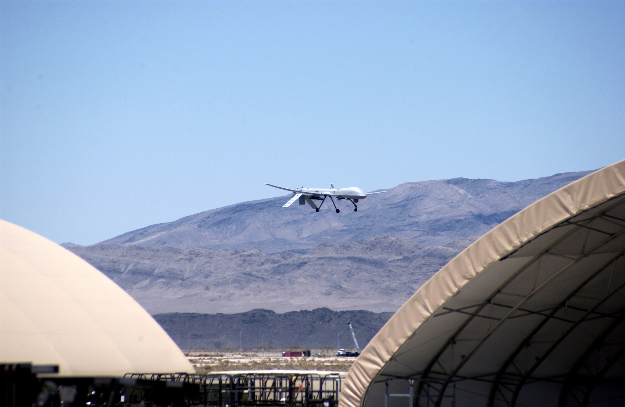 An MQ-1 Predator conducts a low pass commemorating the 250,000th flight hour of the airframe June 22 at Creech Air Force Base, Nev. The Predator is assigned to the 11th Reconnaissance Squadron at Creech AFB. When the Predator is not actively pursuing its primary mission, it acts as the joint forces air component commander-owned theater asset for reconnaissance, surveillance and target acquisition in support of the joint forces commander. (U.S. Air Force photo/Senior Airman Larry E. Reid Jr.) 
