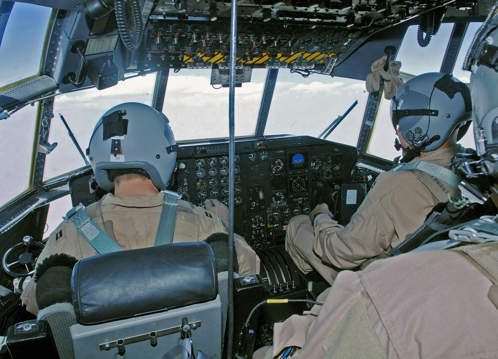 Capt. Scott Simon (left) and Capt. John Malley (right) tend to the controls of a C-130 Hercules during an aeromedical evacuation and airlift mission June 22 from Bagram Air Base, Afghanistan. Captains Simon and Malley are 774th Expeditionary Airlift Squadron C-130 pilots deployed from Wyoming's Air National Guard from Cheyenne, Wyo. (U.S. Air Force photo/Staff Sgt. Craig Seals)
