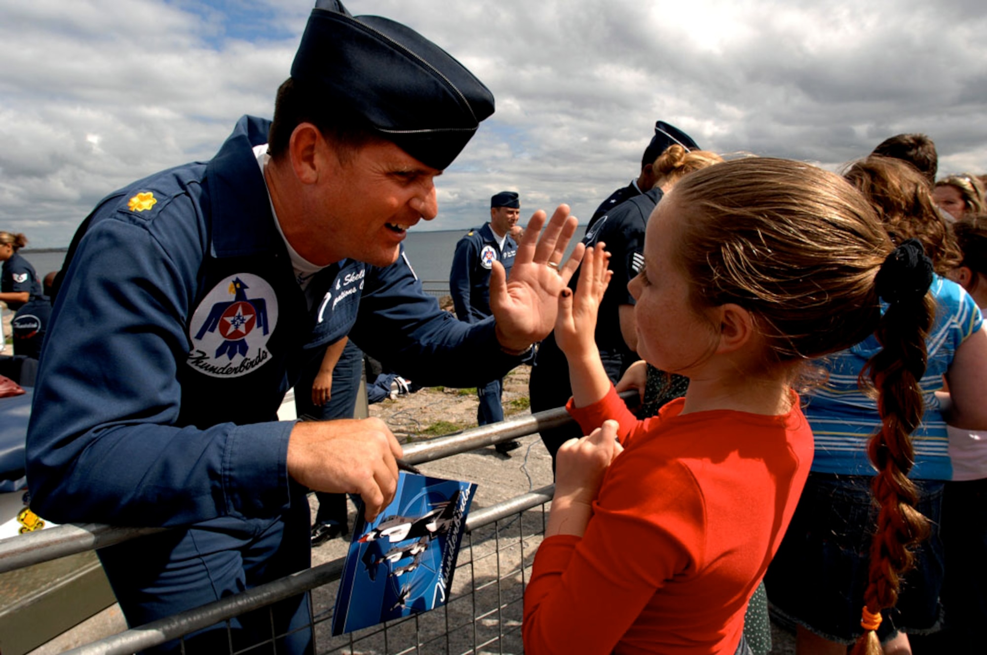 Maj. Rob Skelton, Air Force Thunderbirds operations officer, greets a young girl at the Salthill Air show in Galway, Ireland, June 24. This is the first time in the team's 54-year history the Thunderbirds have performed over Irish soil.  More than 100,000 people attended the air show.  (U.S. Air Force Photo/Tech. Sgt. Justin Pyle)