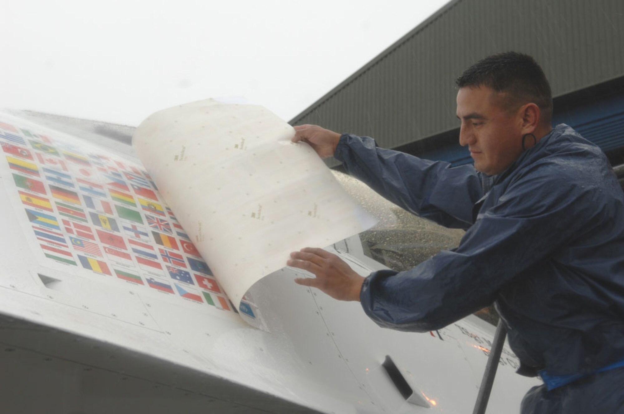 Staff Sgt. Adrian Quezada, an Air Force Thunderbirds assistant dedicated crew chief, unveils the new Thunderbird flag panel, which now includes an Irish flag. This is the first time in the team's 54-year history the Thunderbirds have performed over Irish soil.  More than 100,000 people attended the air show performance in Galway, Ireland, which was the team's first stop on their 2007 European Good Will Tour. (U.S. Air Force Photo/Staff Sgt. Kristi Machado)