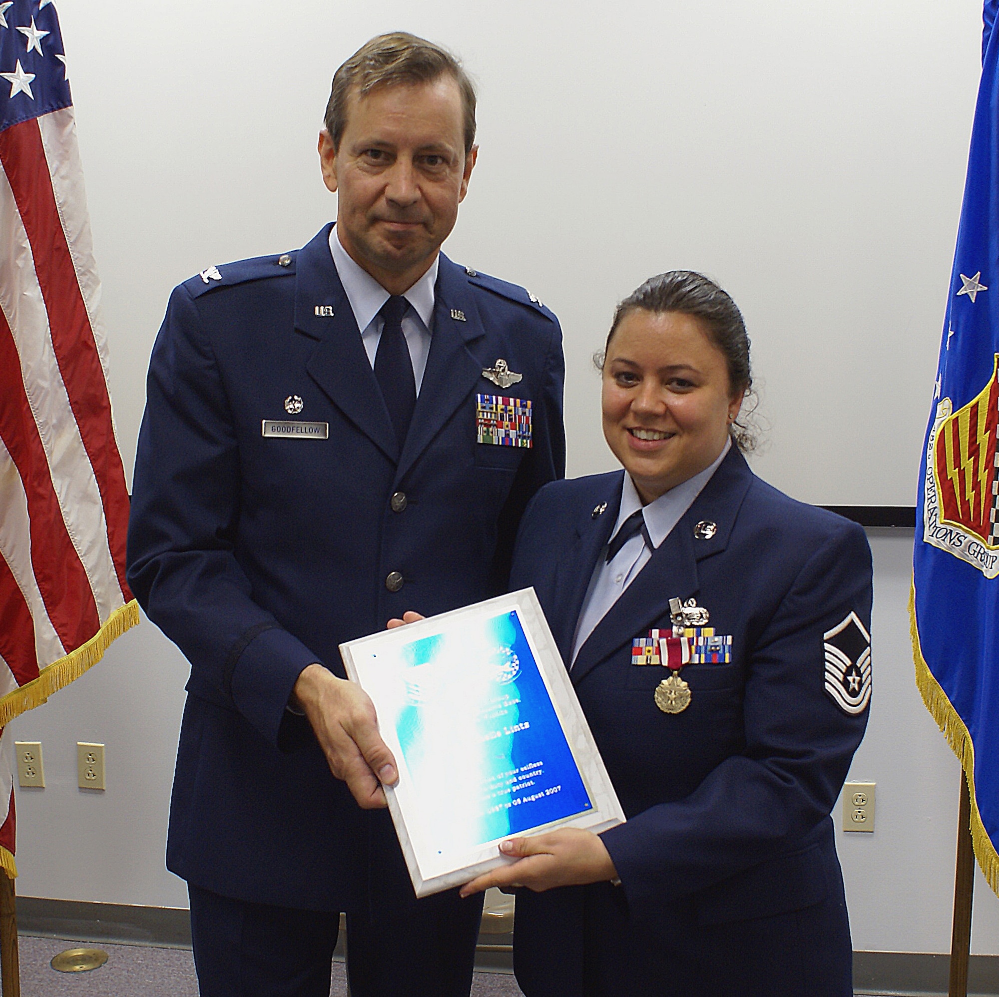 Master Sgt. Danielle Lintz, administrative orderly room NCO in charge, poses with Col. Scott “Foot” Goodfellow, 482nd Operations Group Commander during her retirement ceremony here on June 9. She served here entire Air Force Reserve career at Homestead ARB. (U.S. Air Force photo/Dan Galindo)