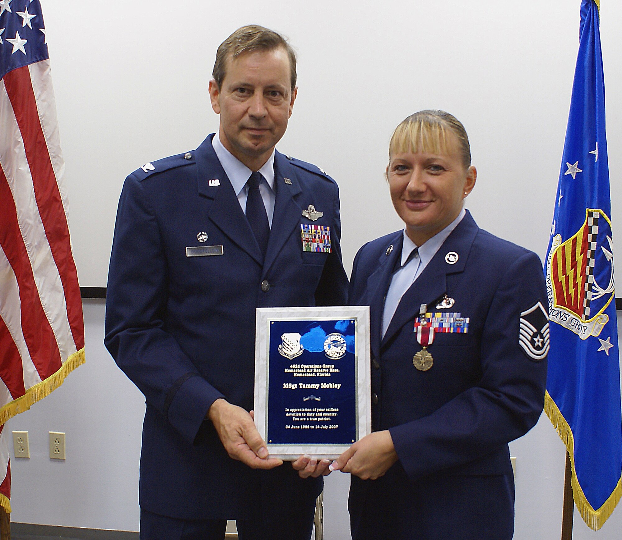 Master Sgt. Tammy Mobley, Career Assistance Advisor, poses with Col. Scott “Foot” Goodfellow, 482nd Operations Group Commander during her retirement ceremony here on June 9. She served five years on active duty prior to joining the Air Force Reserve at Homestead ARB in 1992. (U.S. Air Force photo/Dan Galindo)