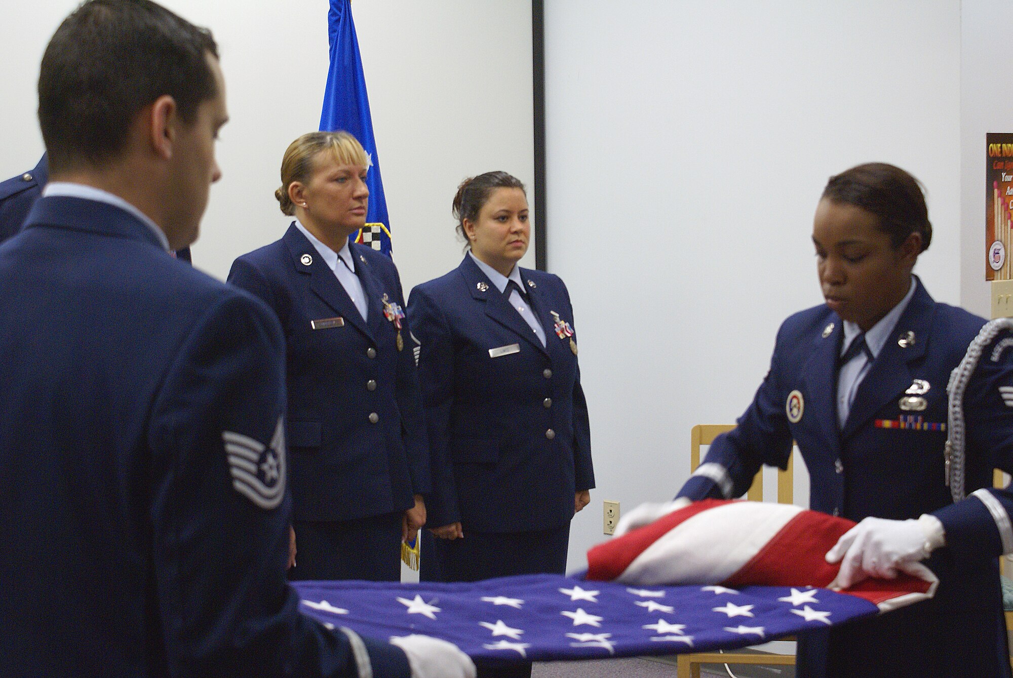 Master Sgt. Tammy Mobley, center-left, and Master Sgt. Danielle Lintz, center-right, retired in a dual ceremony here on June 9. Both reservists were presented with an American Flag in recognition of their service to the Air Force and Air Force Reserve. (U.S. Air Force photo/Dan Galindo)