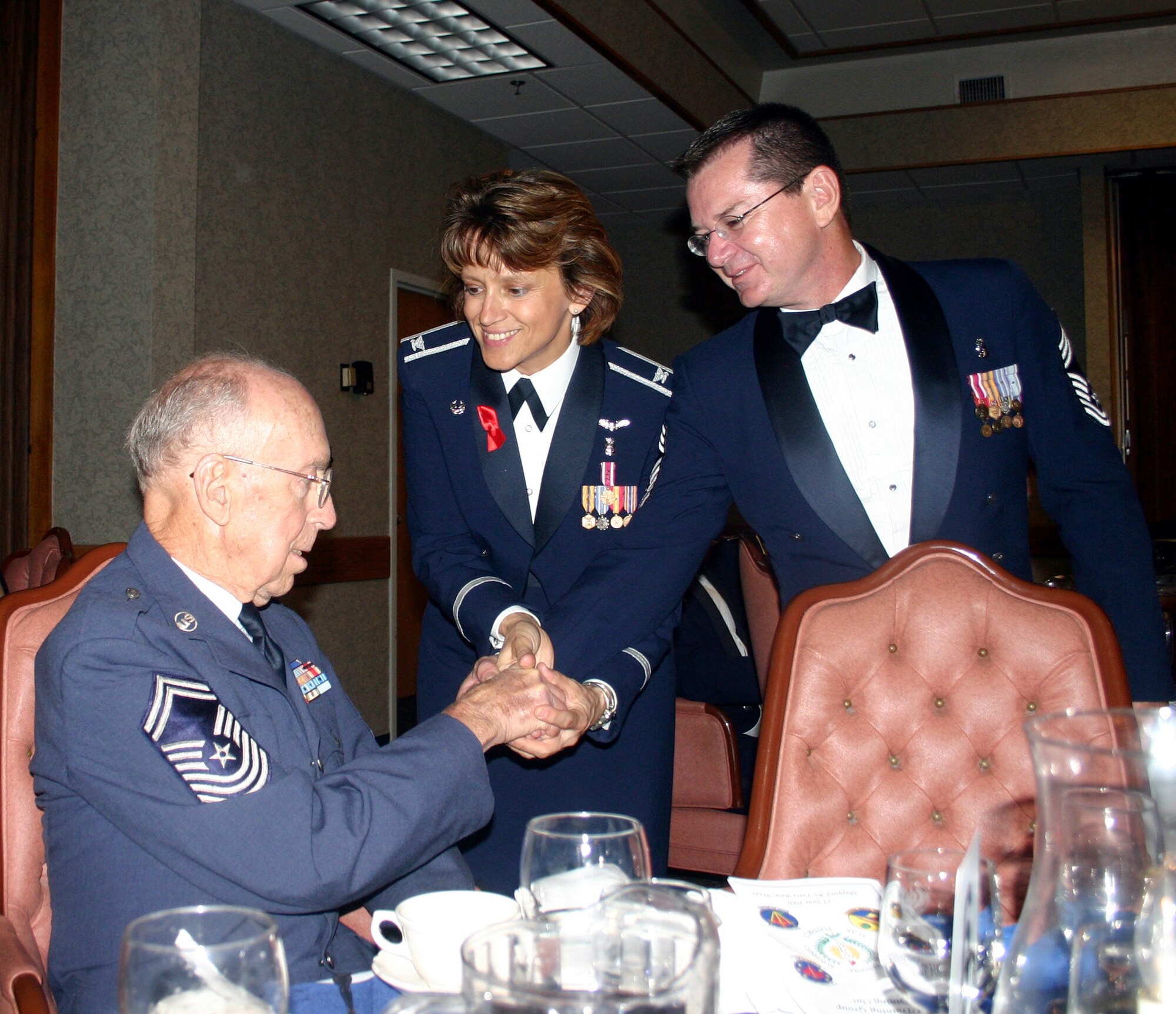 882nd Training Group Commander Col. Nancy Dezell and 882nd TRG Superintendent Chief Master Sgt. Michael Crowley present retired Chief Master Sgt. Don Collier with a coin during the 882nd TRG Dining Out at the Sheppard Club June 23. Chief Collier, who joined the Air Force in 1941, was an honored guest at the event. (U.S. Air Force photo/Staff Sgt. Tonnette Thompson)