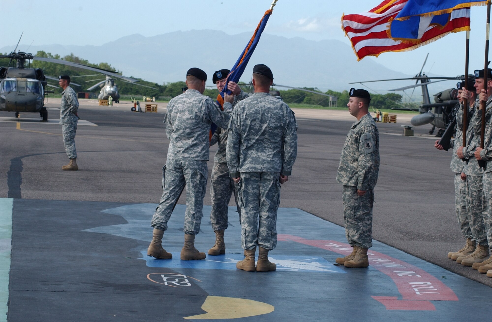 Army Lt. Col. Todd Conyers assumes command of the 1st Battalion 228th Aviation Regiment here by accepting the 1-228 AVN guidon from Brig. Gen. P.K. Keen, U.S. Army South commander, June 26 on the Soto Cano Air Base flightline. Colonel Conyers arrives from MacDill Air Force Base, Fla., where he served as an aviation maintenance and joint operations officer. U.S. Air Force photo by Martin Chahin.