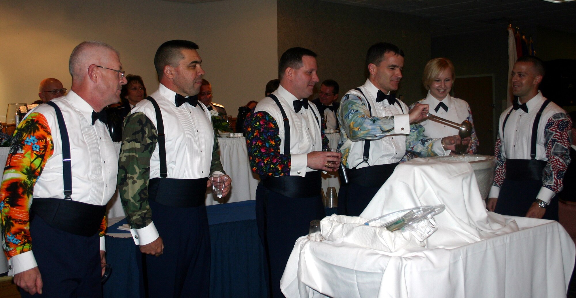A group of attendees, after confessing their "uniform violation," take their punishment at the grog bowl during the 882nd Training Group Dining Out at the Sheppard Club June 23.  From left: Master Sgt. Hugh Mastroni, 383rd Training Squadron; Capt. Tim Christison, 382nd TRS; Lt. Col. Richard Terry, 882nd Training Support Squadron; Lt. Col. London Richard, 382nd TRS; Staff Sgt. Inna Hernandez, 882nd TRSS; Tech. Sgt. Matthew Gross, 382nd TRS. (U.S. Air Force photo/Staff Sgt. Tonnette Thompson)