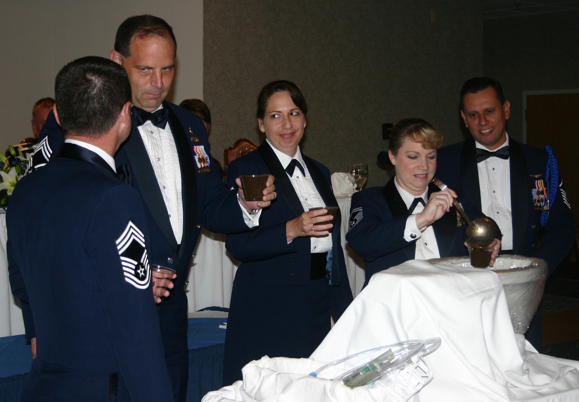 The superintendents prepare to test the grog during the 882nd Training Group Dining Out at the Sheppard Club June 23. From left: Chief Master Sgt. Michael Crowley, 882nd TRG; Chief Master Sgt. Allan Drage, 382nd Training Squadron; Senior Master Sgt. Carolyn Regan, 381st TRS; Senior Master Sgt. Lisa Richards, 383rd TRS; Master Sgt. Ralph Cuevas, 882nd TRSS. (U.S. Air Force photo/Staff Sgt. Tonnette Thompson)