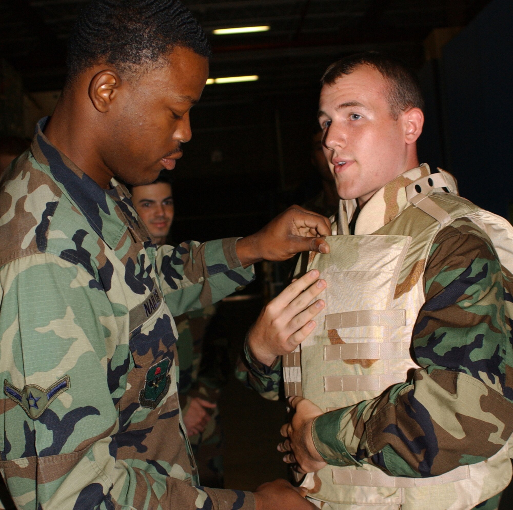 Airman Curtis Nailor, left, 81st Supply Squadron, helps Cadet William Cum-mings from Rutgers Uni-versity try on body armor used for deployment that’s stored in the supply warehouse.  Cadet Cummings participated in the first of five week-long sessions of Aerospace 100 specialty training, commonly called ASSIST.  The program’s goal is to recruit, retain and train cadets by exposing them to the daily operations of an active-duty base.  The last two sessions are July 18-22 and July 16-20. (U. S. Air Force photo by Kemberly Groue)