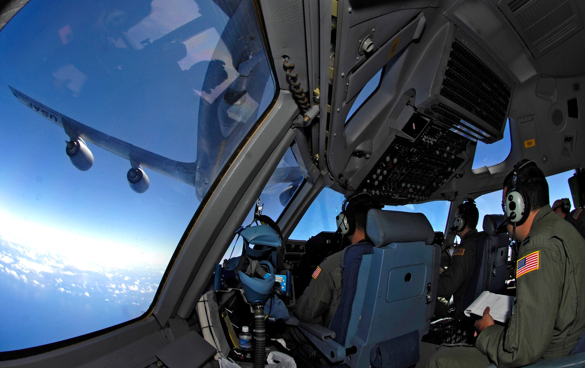 C-17 Globemaster III aircrew members practice aerial refueling as their aircraft receives fuel from a KC-135 Stratotanker June 22 during a refueling training mission over the Pacific Ocean. The C-17 from the 535th Airlift Squadron at Hickam Air Force Base, Hawaii, and the KC-135 from the 909th Air Refueling Squadron at Kadena Air Base, Japan, are practicing for the upcoming 2007 Air Mobility Command Rodeo. (U.S. Air Force photo/Tech. Sgt. Shane A. Cuomo)