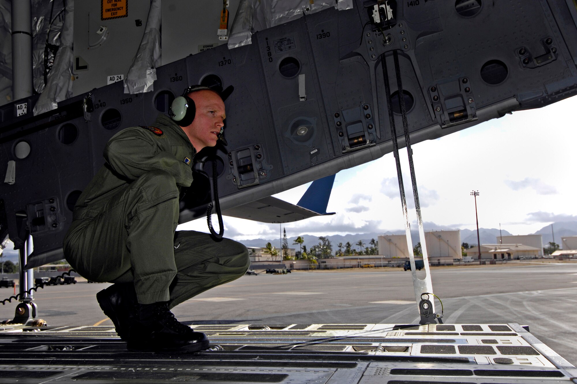 Tech. Sgt. Ansen Lucas helps direct the backing of a C-17 Globemaster III June 22 at Hickam Air Force Base, Hawaii. Sergeant Lucas is a loadmaster with the 535th Airlift Squadron and practicing for the upcoming 2007 Air Mobility Command Rodeo. (U.S. Air Force photo/Tech. Sgt. Shane A. Cuomo) 