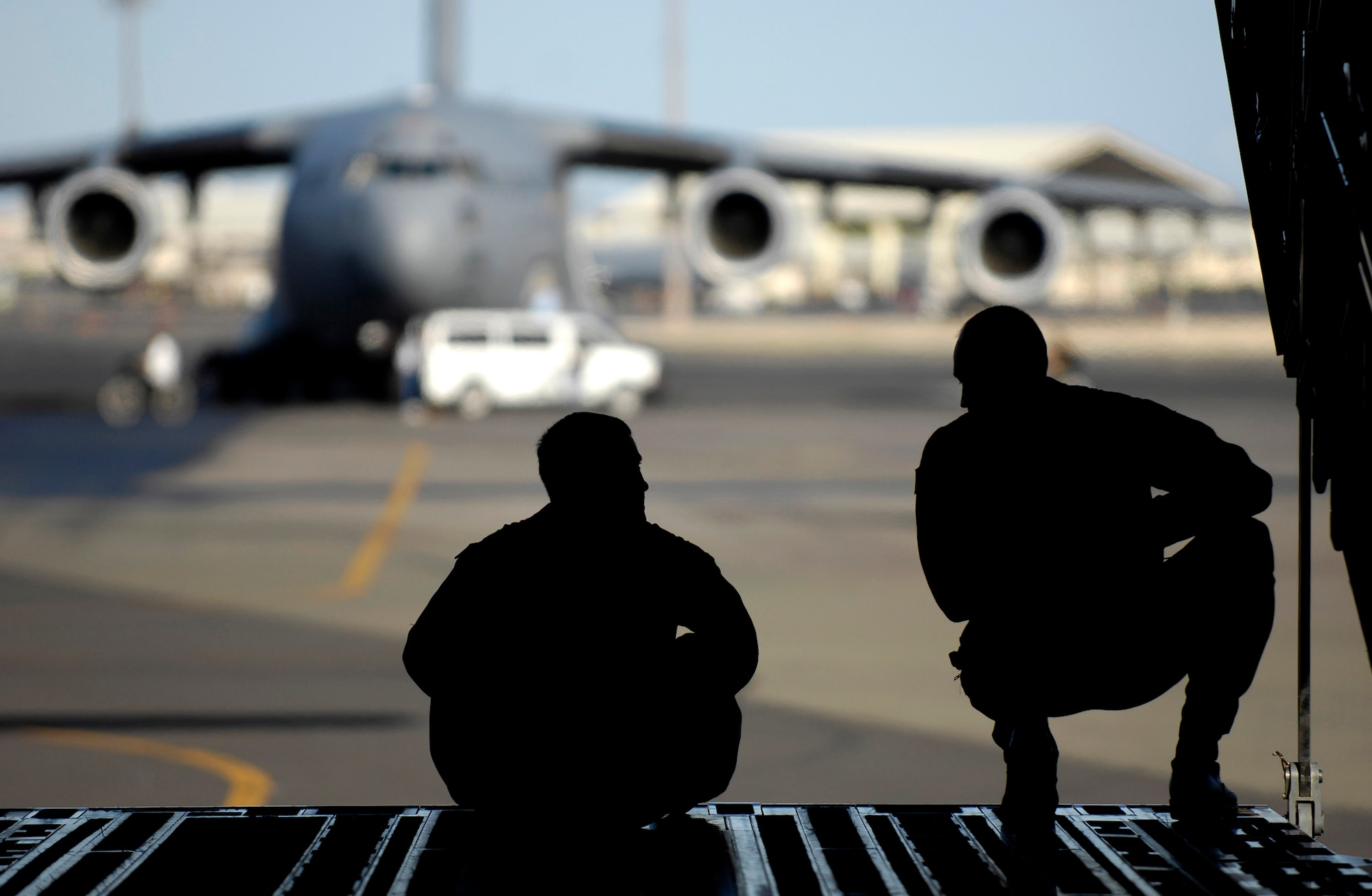 Maj. Jason Mills and Tech. Sgt. Ansen Lucas discuss techniques for backing their C-17 Globemaster III prior to departing June 22 on a refueling training mission from Hickam Air Force Base, Hawaii. A KC-135 Stratotanker from the 909th Air Refueling Squadron, Kadena Air Base Japan is at Hickam AFB practicing with the C-17 crew from the 535th Airlift Squadron for the 2007 Air Mobility Command Rodeo. Sergeant Lucas is a loadmaster and Major Mills is a pilot with the 535th AS. (U.S. Air Force photo/Tech. Sgt. Shane A. Cuomo) 
