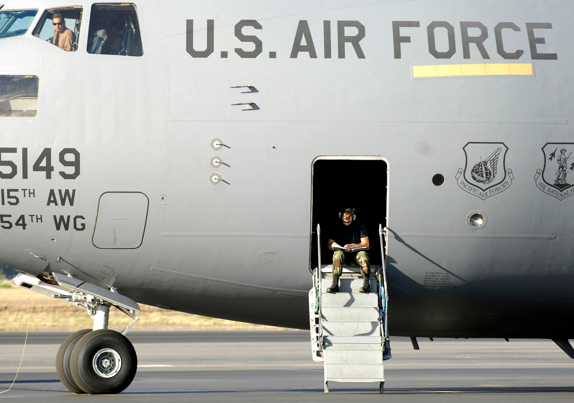 Crew chiefs look over their maintenance logs June 22 while working on a C-17 Globemaster III at Hickam Air Force Base, Hawaii. The crew chiefs are from the 15th Aircraft Maintenance Squadron. (U.S. Air Force photo/Tech. Sgt. Shane A. Cuomo) 