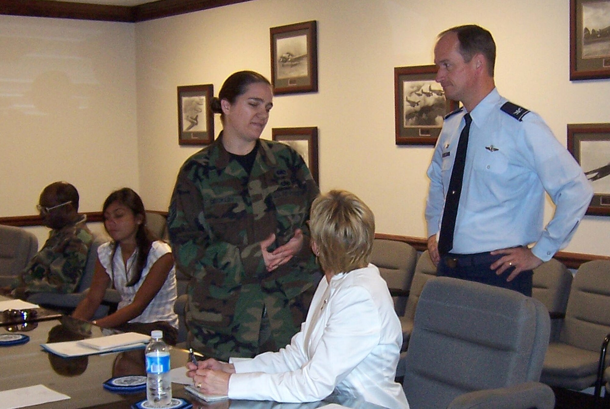 Colonel Dave Gerber, 14th Flying Training Wing Commander, talks with Tech. Sgt. Heather Deckley, 14th Mission Support Group, during the Education Task Force Meeting Tuesday in the Wing Conference Room. (U.S. Air Force Photo by Senior Airman John Parie)