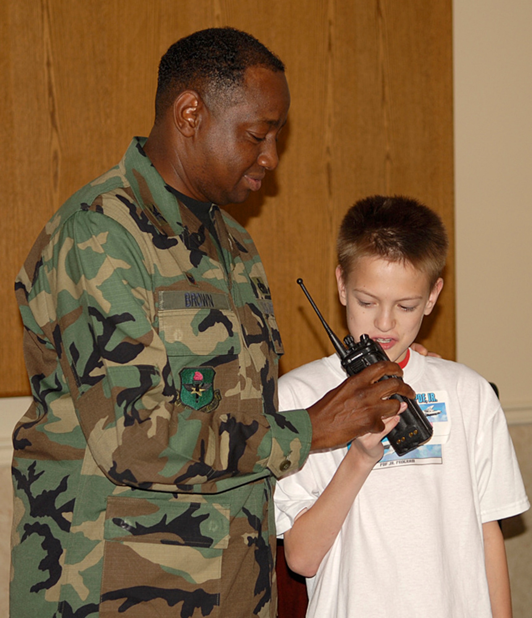 Colonel Mark Brown, 14th Mission Support Group Commander, interacts with a youth at the PDF Jr. hosted by the Airman and Family Readiness Center Friday. Youth received identification cards and were fingerprinted during the event. (U.S. Air Force Photo by Elizabeth Owens)