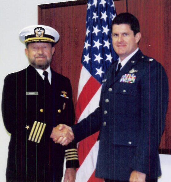 Retired Navy Capt. Dale Kaiser, left, congratulates his son, Lt. Col. Keith Kaiser, after promoting him in 1998. Capt. Kaiser had the privilege of commissioning his son in the Air Force, tacking on second lieutenant bars, major, and lieutenant colonel. June 29, Captain Kaiser will retire his son in the same Navy dress blues he's worn since 1954. (Photo provided by Linda Kaiser)