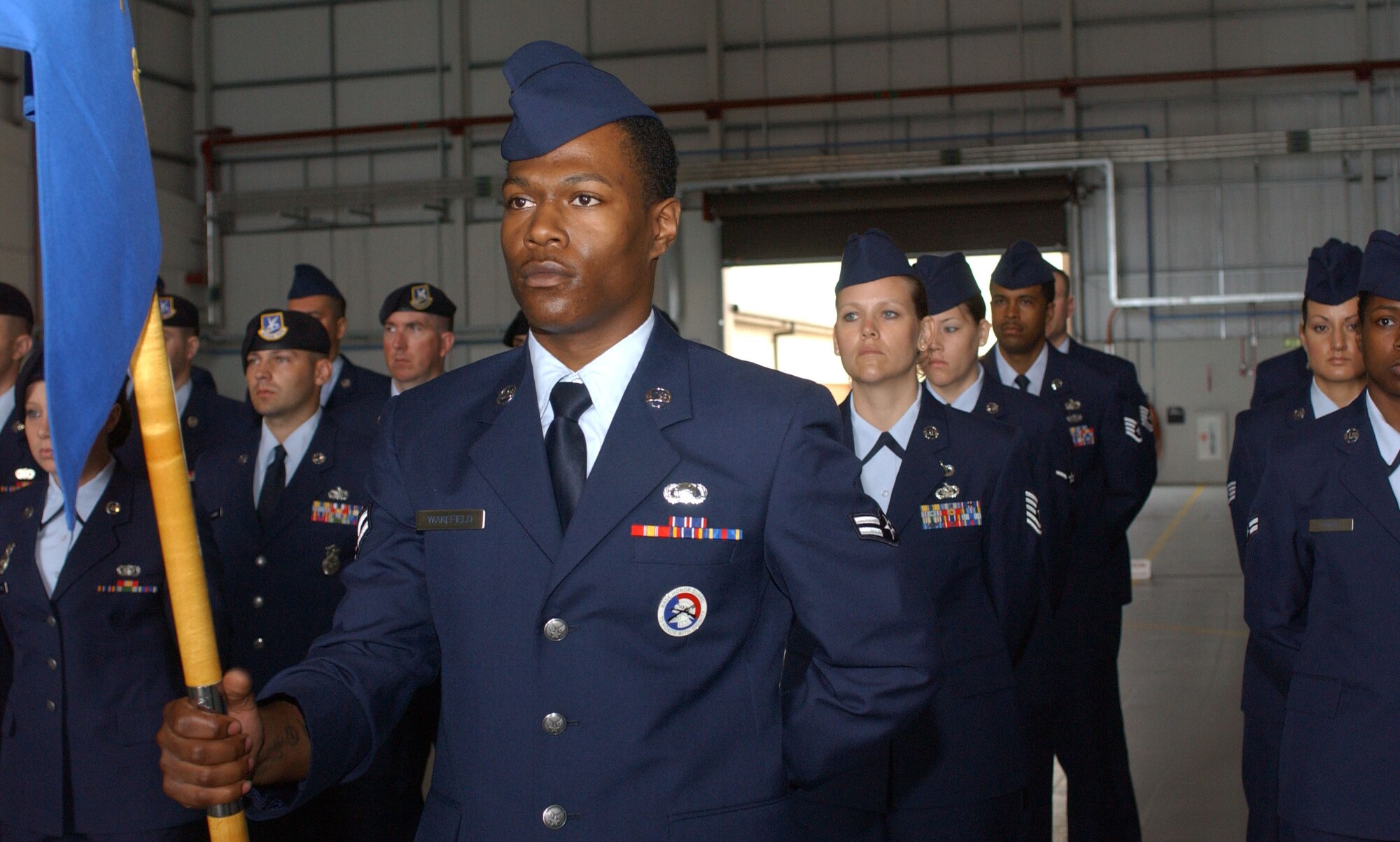 Airman 1st Class Marlon Wakefield, 100th Mission Support Squadron, stands as guidon bearer during the 100th Air Refueling Wing change of command June 22. (U.S Air Force photo by Brad Smith)                                                             
