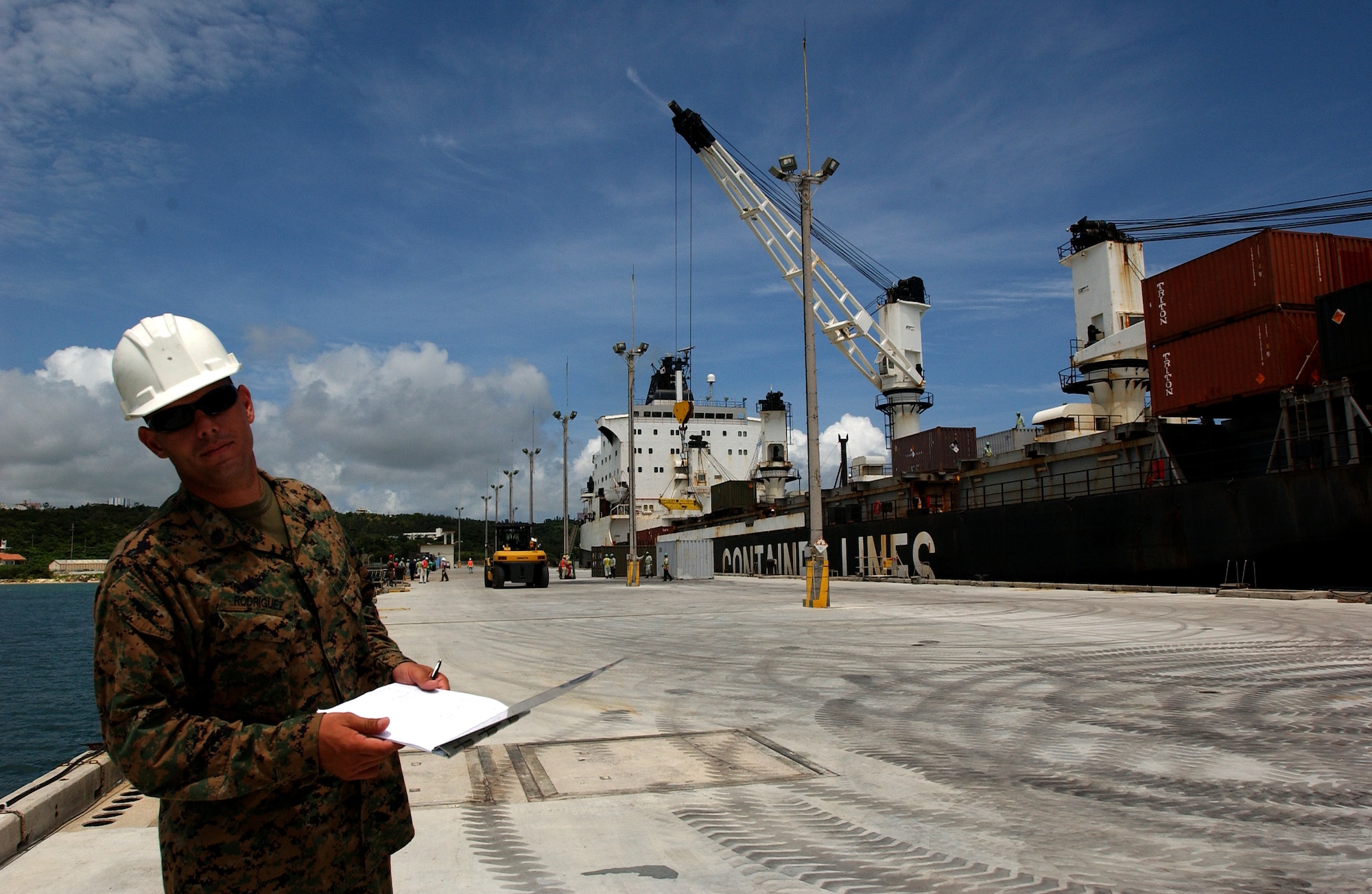 Staff Sgt. Cecilio Rodriguez, U.S. Marine Corps pier safety loading officer, assures containers are downloaded safely from the Motor Vessel Global Patriot ship and inventoried during the Turbo Containerized Ammunition Distribution System exercise June 21.  The containers were filled with new munitions for all services in Okinawa.  The following day many containers filled with older munitions were onloaded to be shipped back to military installations in the U.S. for storage. U.S. Air Force photo/Staff Sgt. Reynaldo Ramon