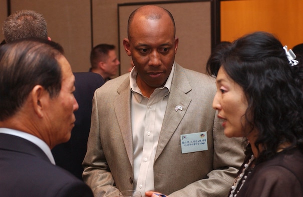 KUNSAN AIR BASE, Republic of Korea -- Col. CQ "Wolf" Brown, 8th Fighter Wing commander, talks with Gunsan City Mayor, Moon, Dong Shin, and Rosemary Song, 8th FW Public Affairs Office Community Relations Chief at the officer's club June 22. Colonel Brown hosted a dinner for eight Gunsan City civic leaders, including Mayor Moon.  The dinner provided a chance for Kunsan Air Base to build relationships with host-nation civic leaders and partners from Gunsan City. (U.S. Air Force photo/Senior Airman Steven Doty) 
                                                            
                             