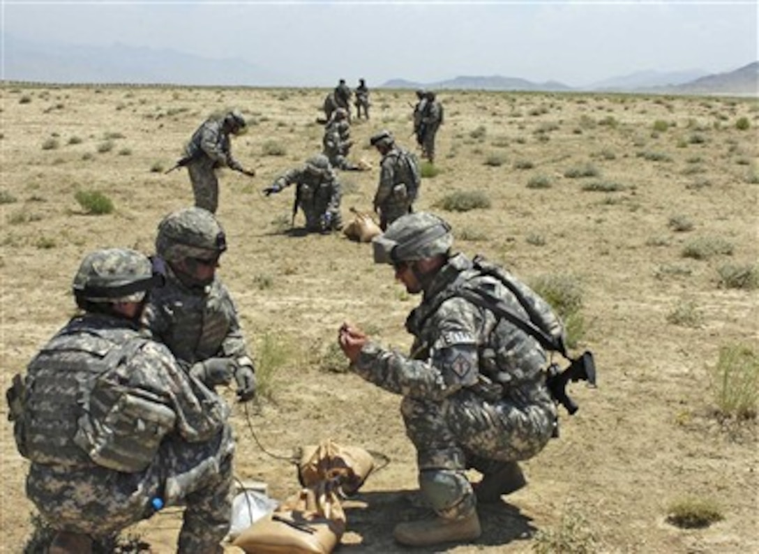 Coalition soldiers work with composition C-4, military explosive material, during a demolition range at East River Range, Bagram, Afghanistan. 