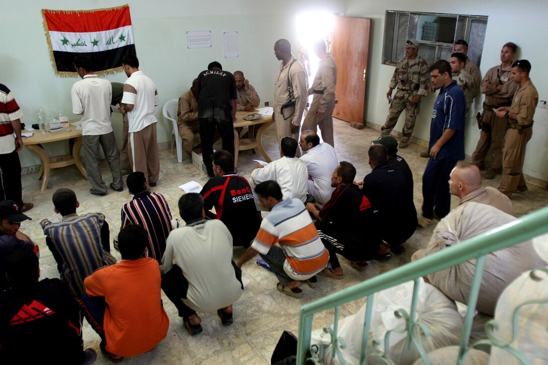 Marines and Sailors screen Iraqi civilians before they can become part of the neighborhood watch in Fallujah on 29 June. Marines and Sailors with 2nd Battalion, 6th Marine Regiment, Regimental Combat Team 6, continue to push on with Operation Alljah to provide stability and protection for the citizens of Fallujah. Sectioning the city into precincts, Marines work with the Iraqi Police and Army to set up operational stations where Iraqi civilians come in to receive identification cards, food, reimbursements and a chance to join the neighborhood watch program.