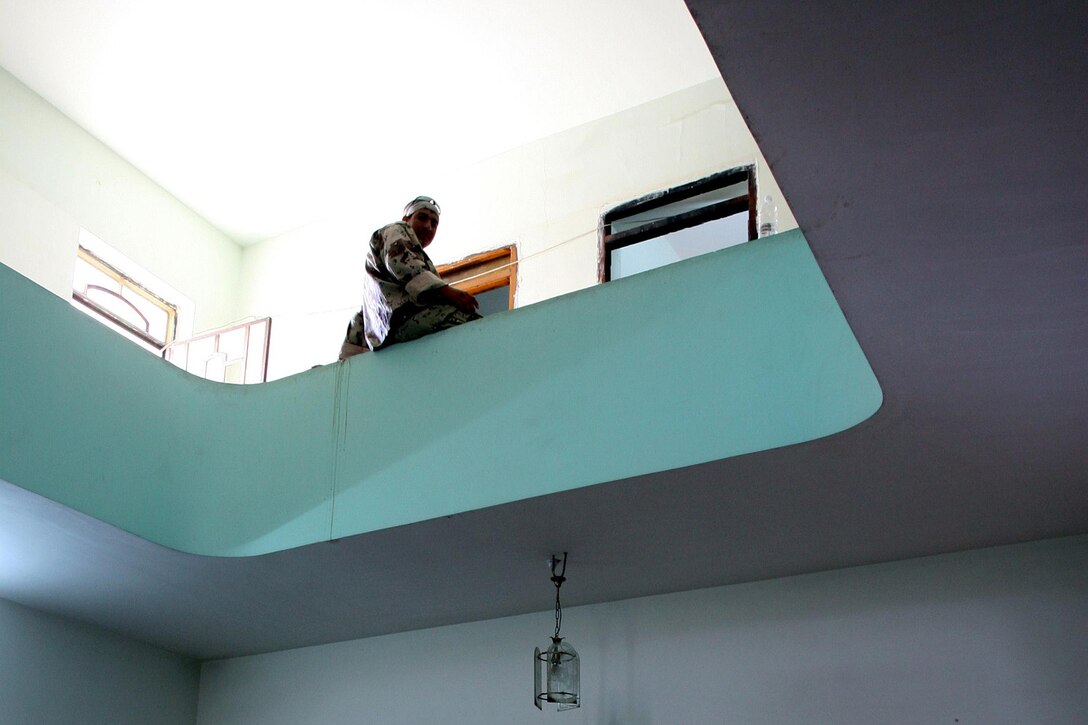 An Iraqi Army soldier sits on a ledge inside a police precinct in Fallujah on June 30. Marines and Sailors with 2nd Battalion, 6th Marine Regiment, Regimental Combat Team 6, continue to push on with Operation Alljah to provide stability and protection for the citizens of Fallujah. Sectioning the city into precincts, Marines work with the Iraqi Police and Army to set up operational stations where Iraqi civilians come in to receive identification cards, food, reimbursements and a chance to join the neighborhood watch program.