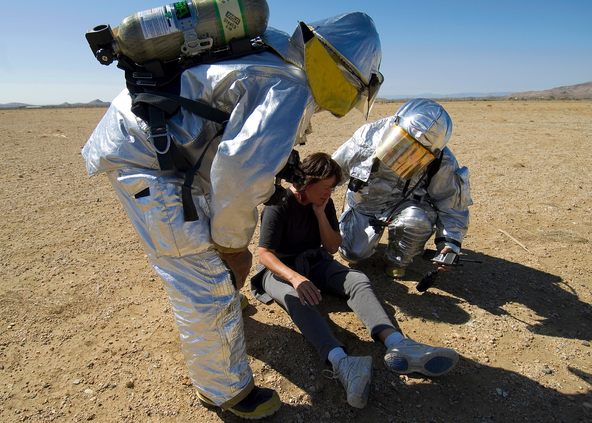 Edwards firemen check a "victim" of a simulated B-2 Bomber crash at Mojave, Calif., June 18 during the base’s Operational Readiness Exercise. Team Edwards performed its ORE from June 18 through June 21 in preparation for the upcoming Air Force Materiel Command Inspector General Operational Readiness Inspection Phase I retest in July. (Photo by Mike Cassidy)