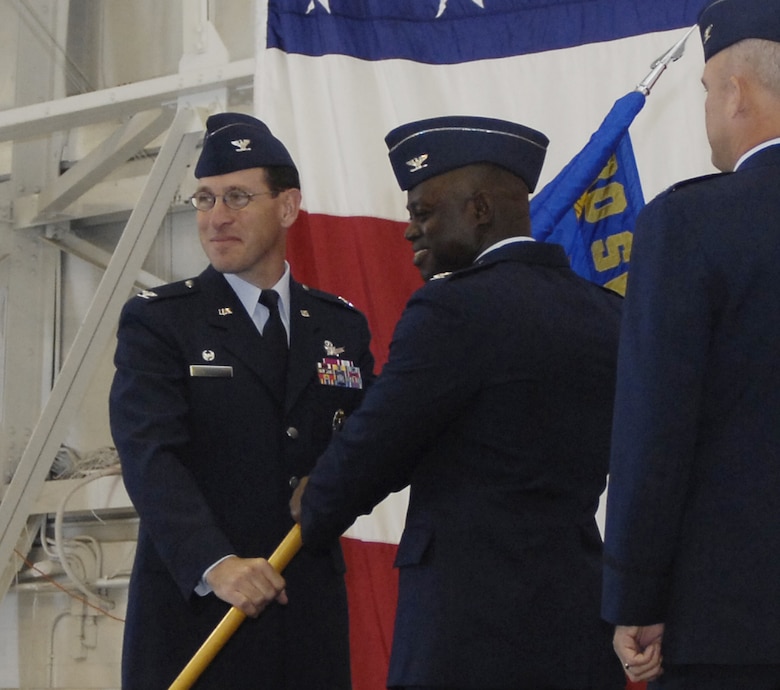 30th Space Wing Commander Col. Stephen Tanous gives command of the 30th Operations Group to Col. Andre Lovett during a change of command ceremony at the 76th Helicopter Squadron hangar June 22.  (U.S. Air Force photo/Airman 1st Class Johnathan Olds)